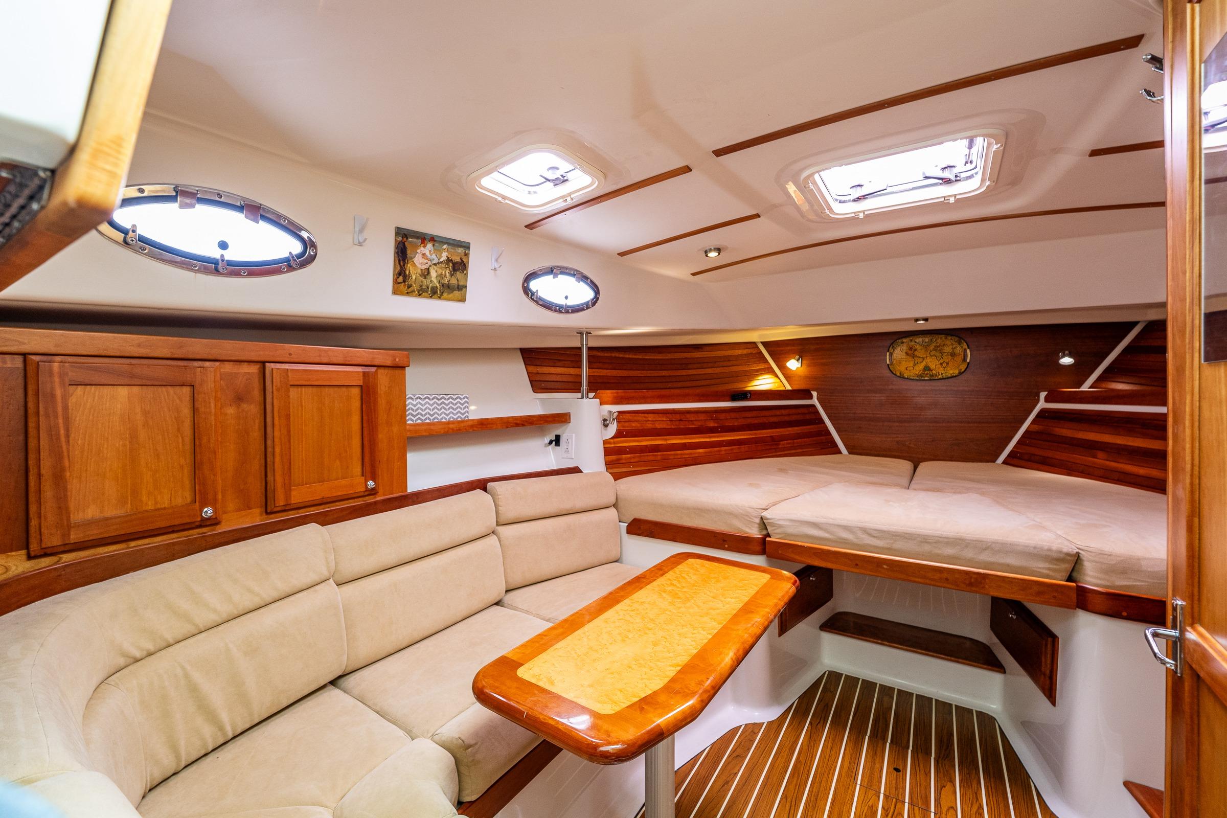 Luxurious interior of 2008 Back Cove 33 yacht with cozy seating and elegant wood finishes.
