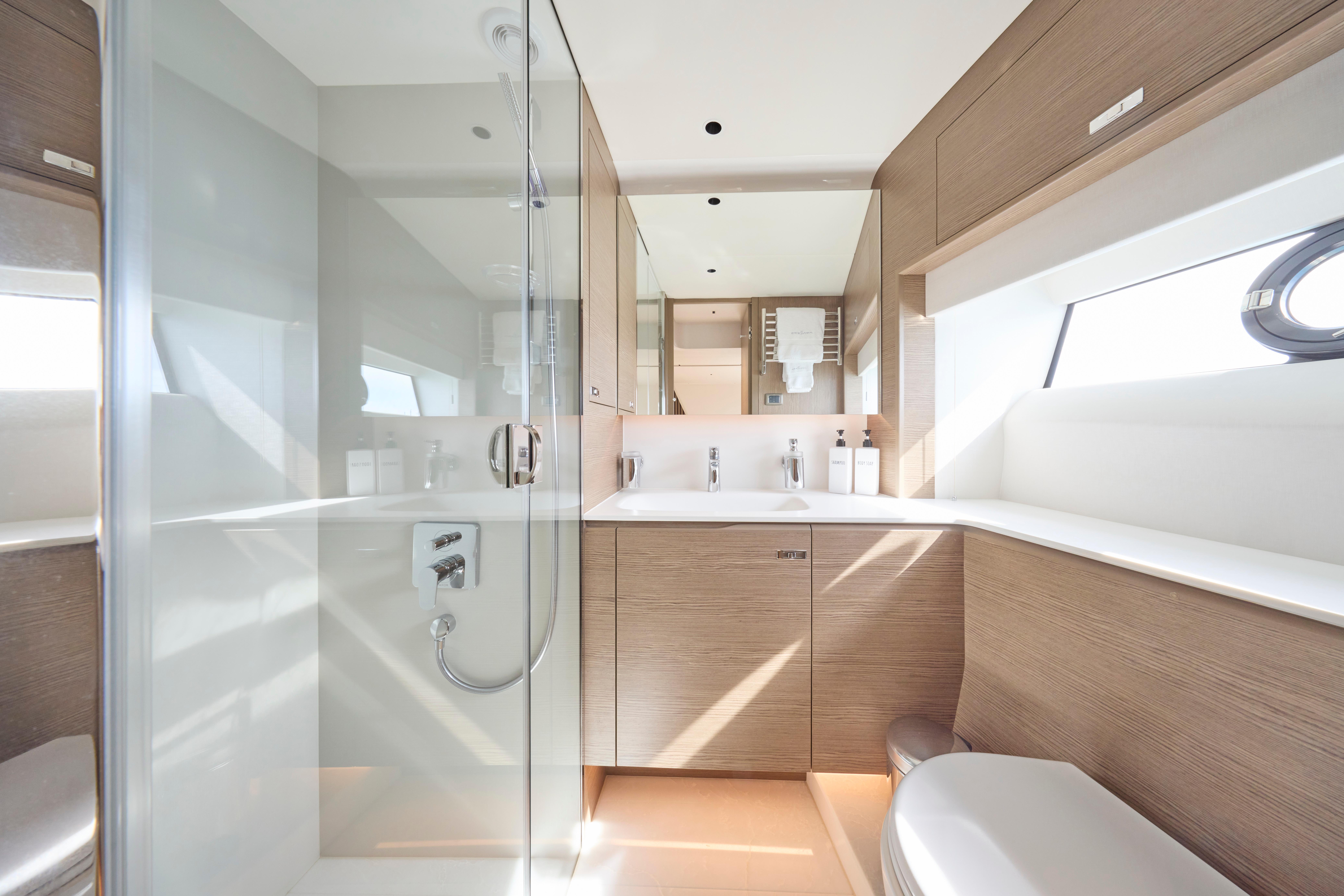 Luxurious bathroom in 2024 Princess Y85 yacht with modern fixtures and glass shower.