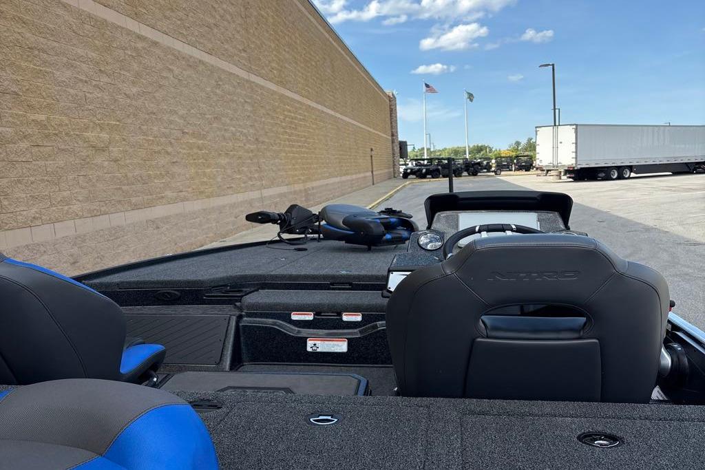 2026 Nitro Z20 XL Pro boat parked near a brick wall under a clear sky.
