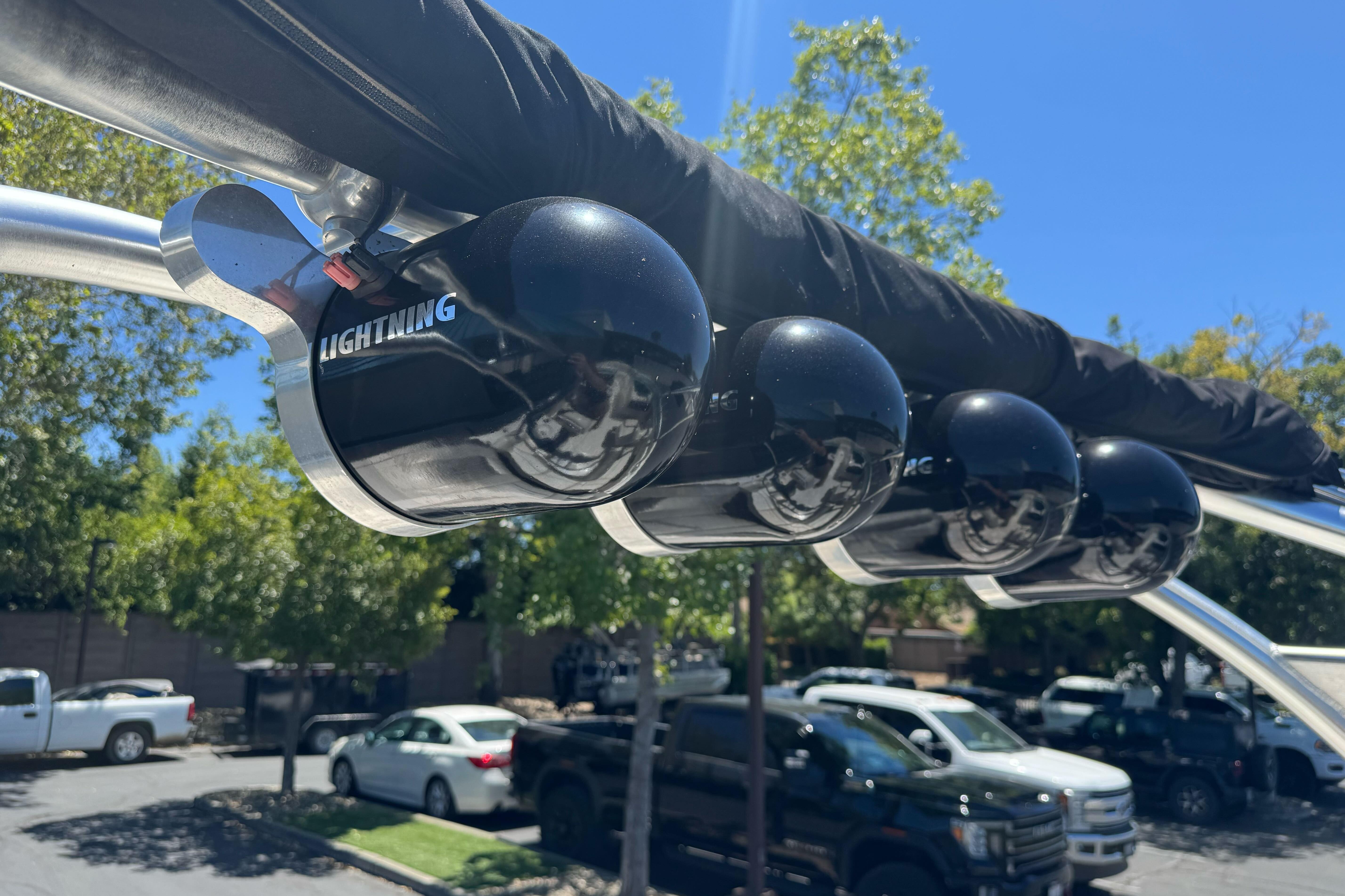 Rooftop speakers on a 2007 Sea Ray SLX 250 boat, under a clear blue sky.