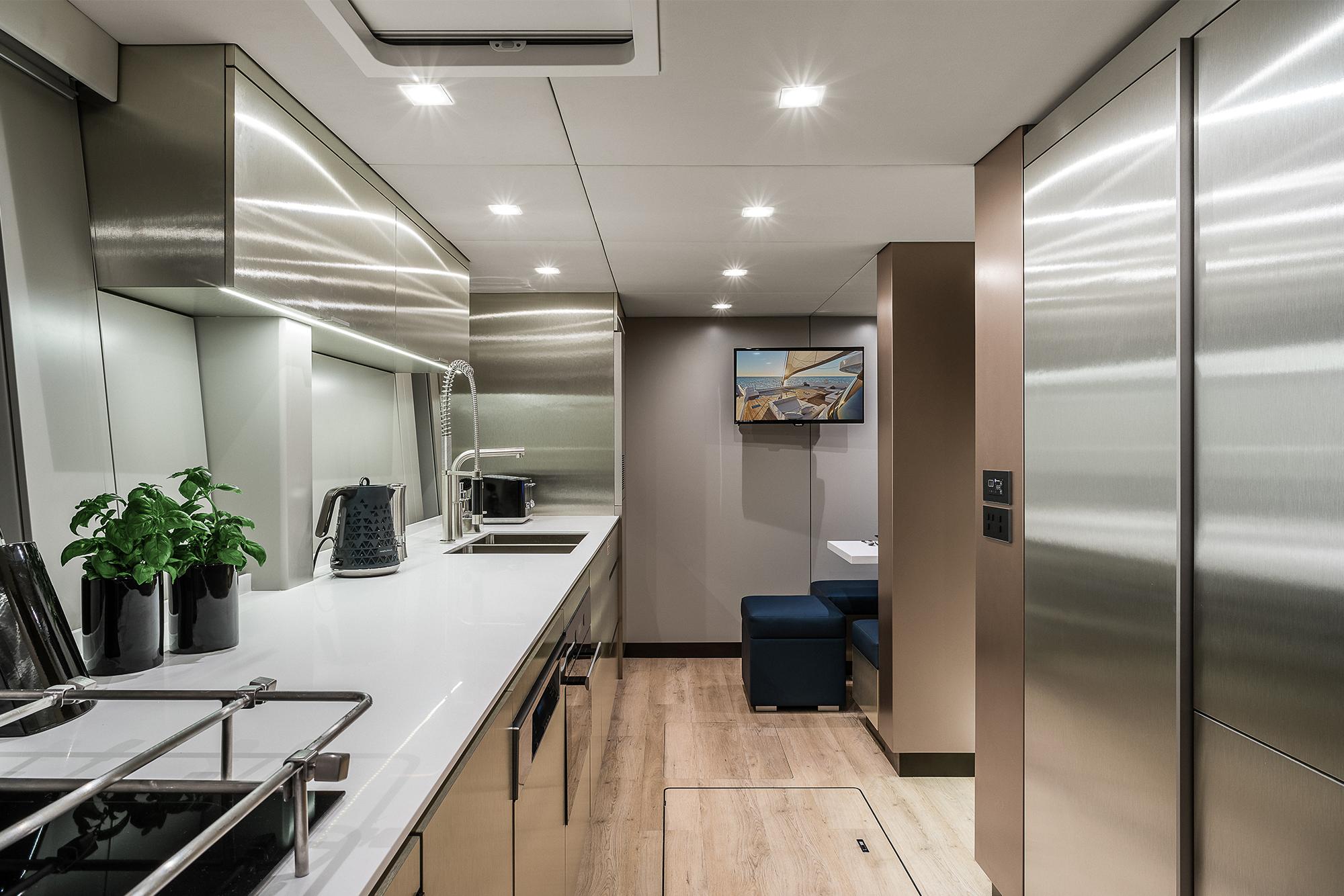 Luxurious modern kitchen interior on 2026 Sunreef 80 yacht, featuring sleek stainless steel design.