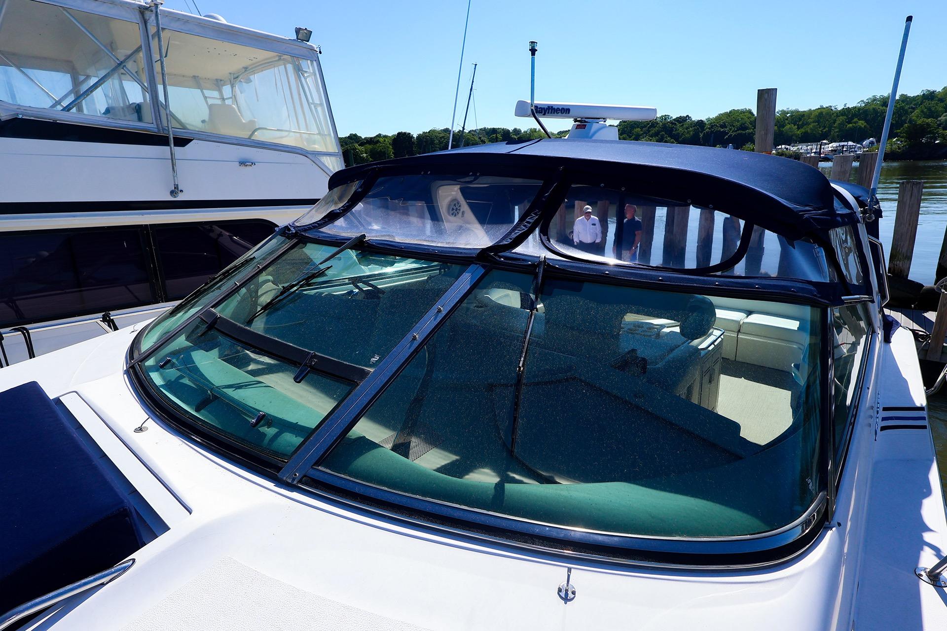 1998 Sea Ray 500 Sundancer yacht docked, featuring sleek design and spacious interior.