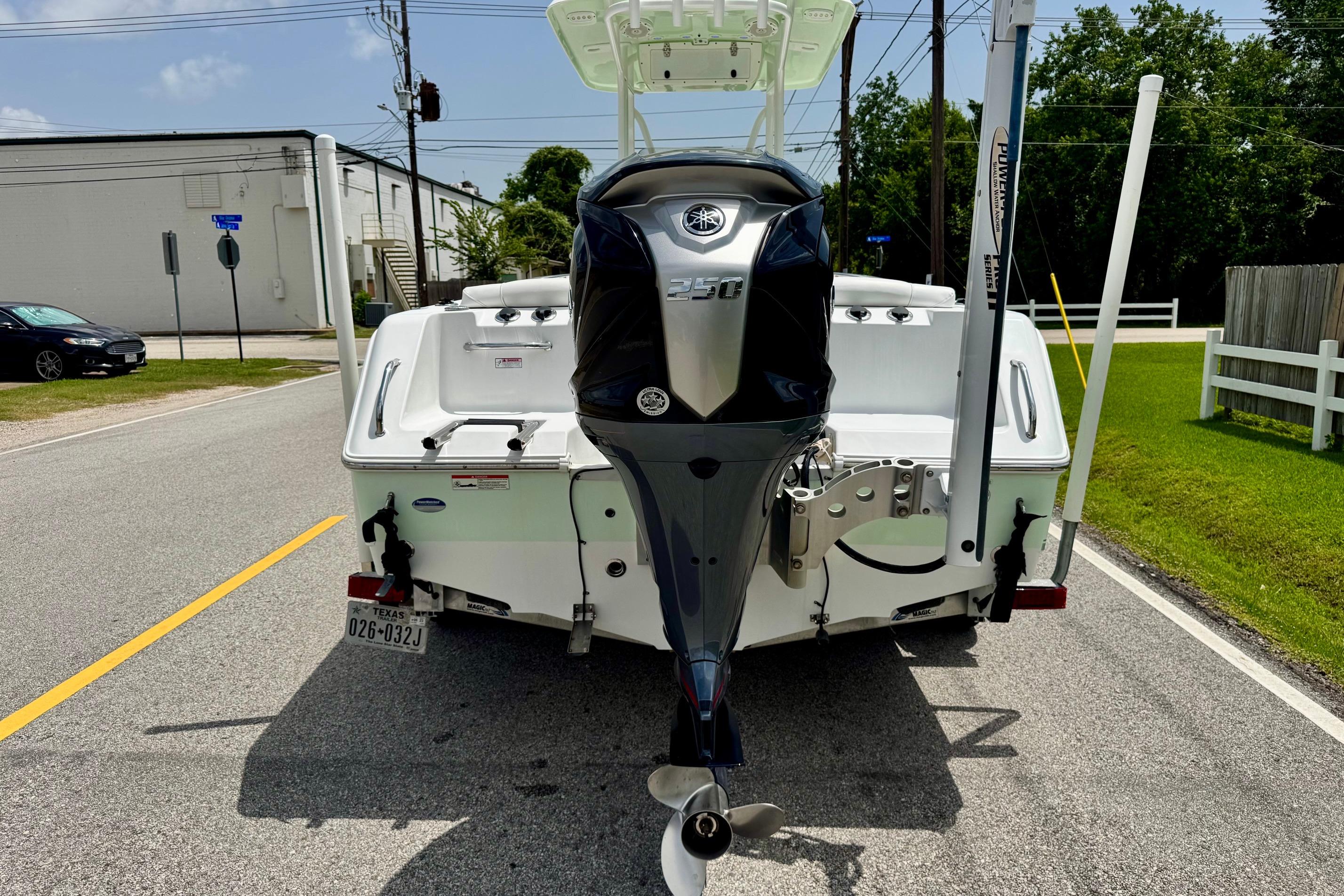 2015 Sea Hunt Ultra 234 boat with Yamaha outboard motor on a street.