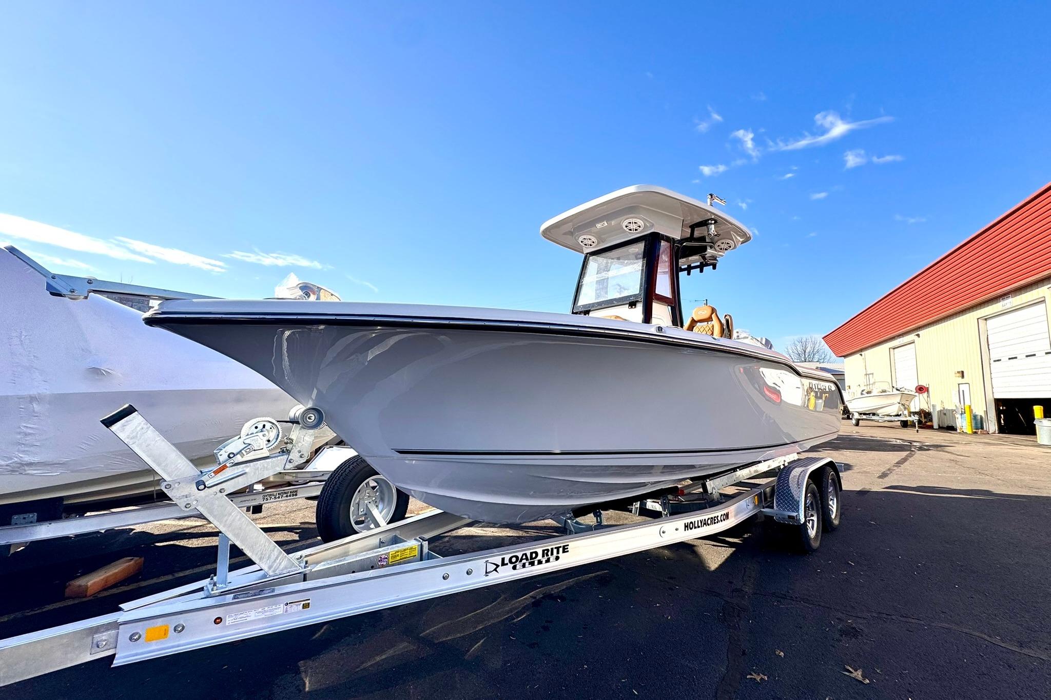 2026 Key West 239 FSR boat on trailer under clear blue sky.