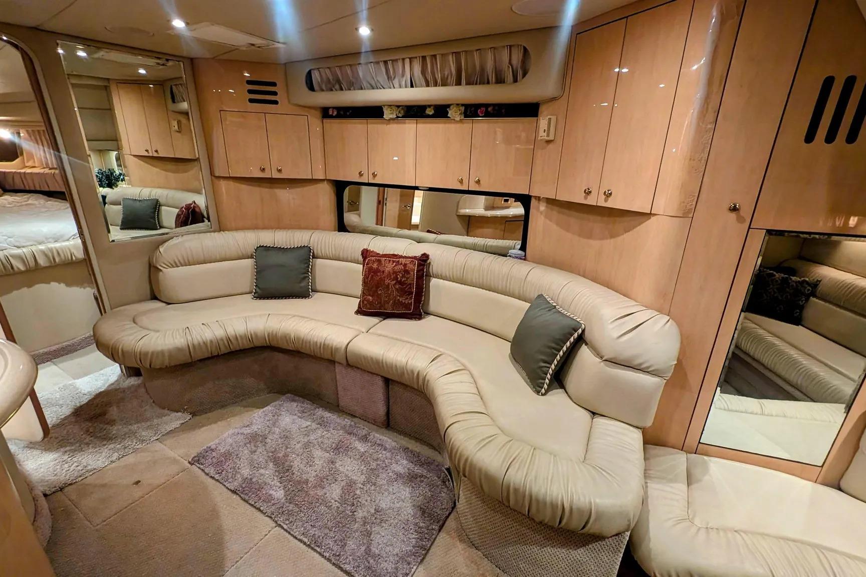 Luxurious interior of 2000 Sea Ray 380 Sundancer yacht with plush seating and elegant cabinetry.