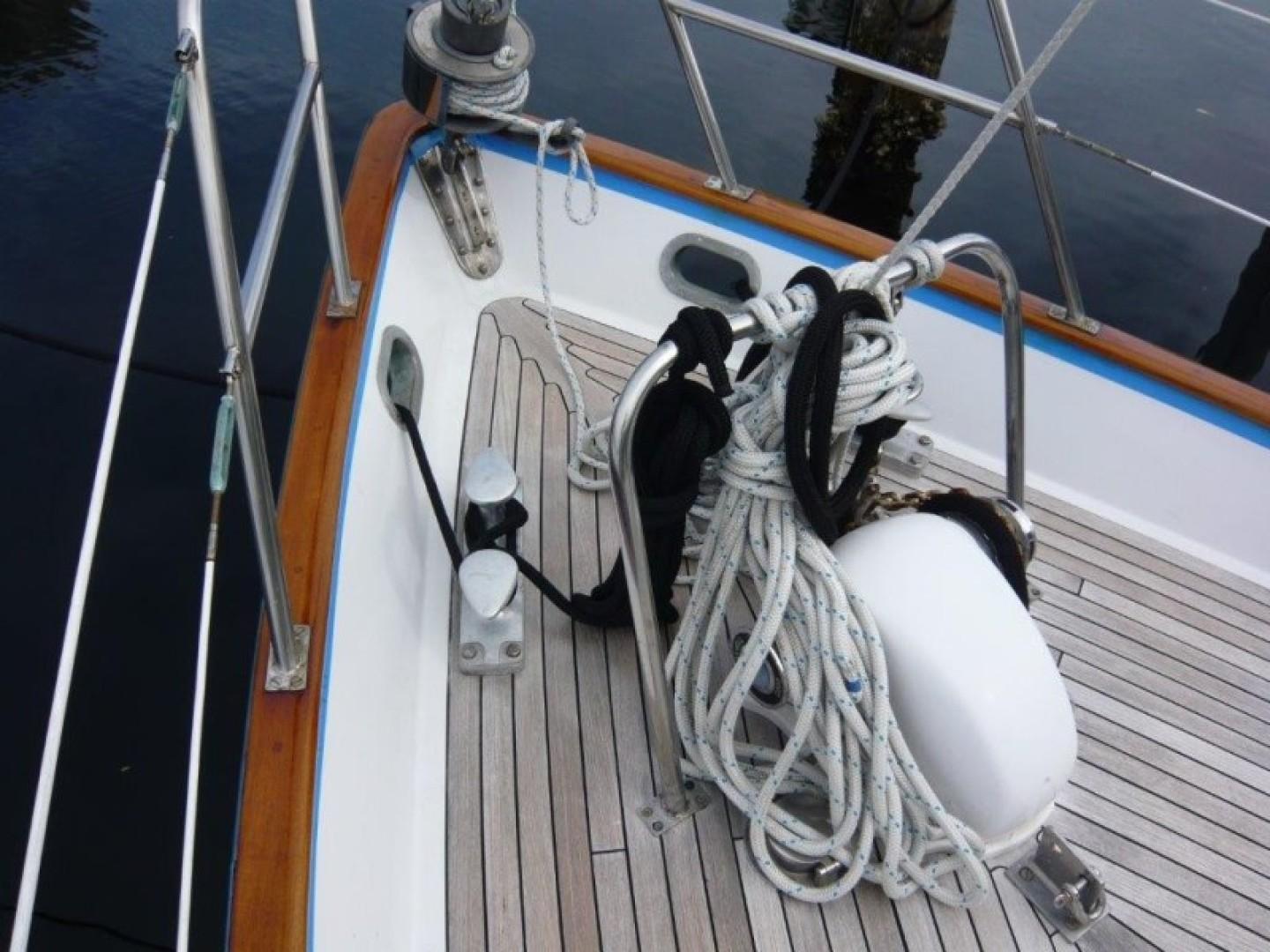Deck of 1990 Cheoy Lee Sloop with ropes and railing.