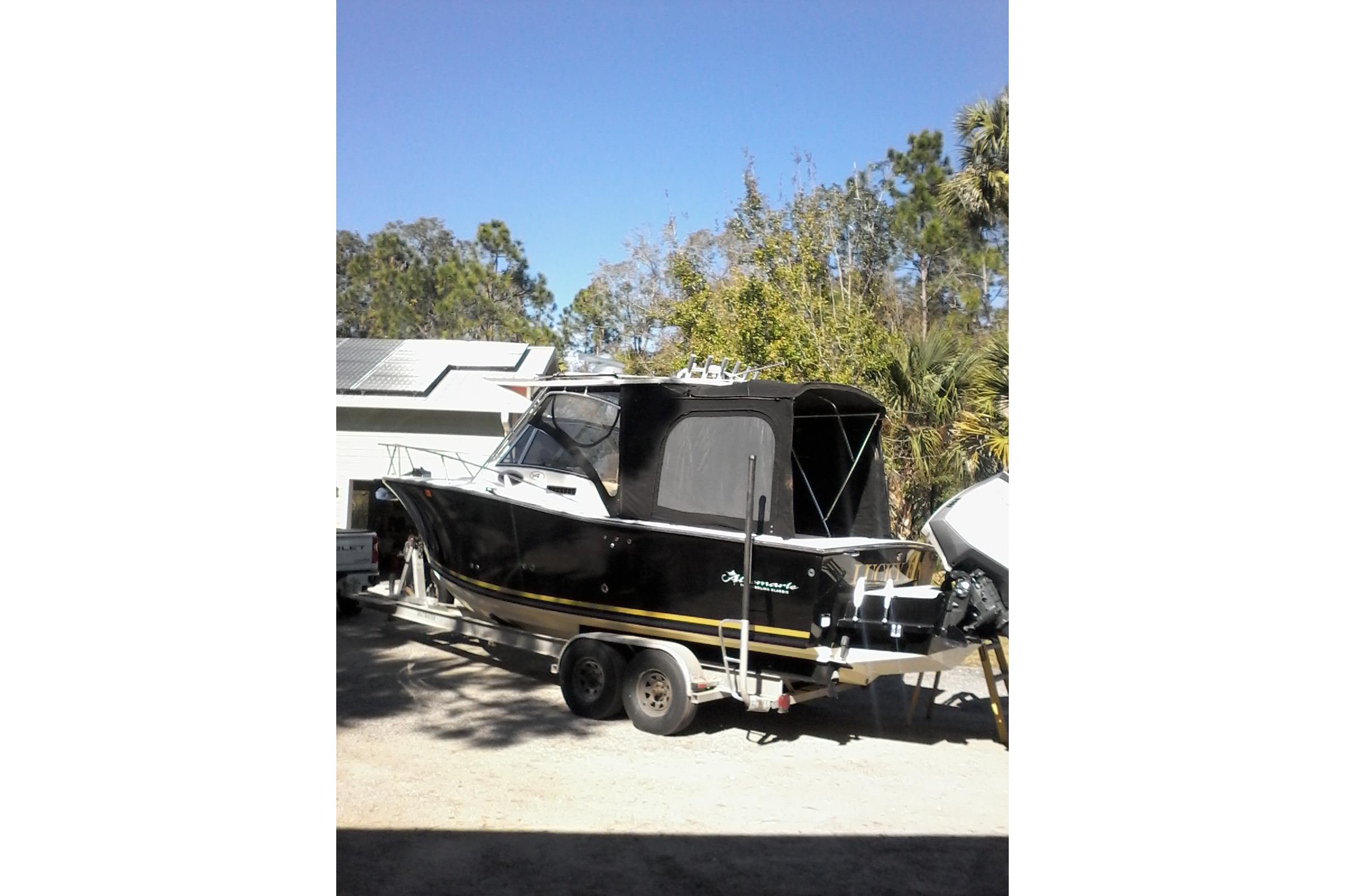 2002 Albemarle 265 Express Fisherman boat on trailer, parked outdoors.