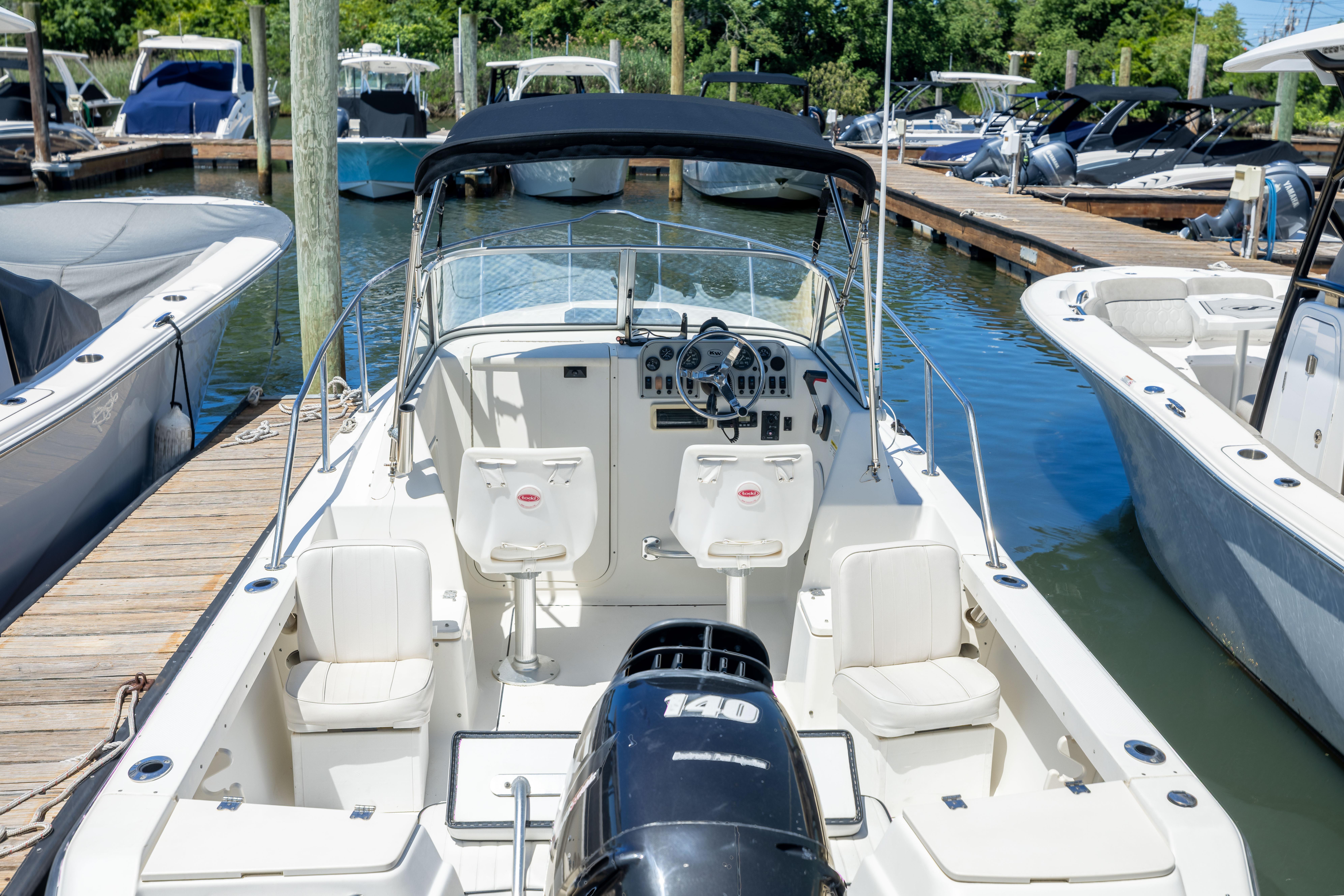 2020 KEYWEST WA boat docked at marina, featuring spacious seating and modern controls.