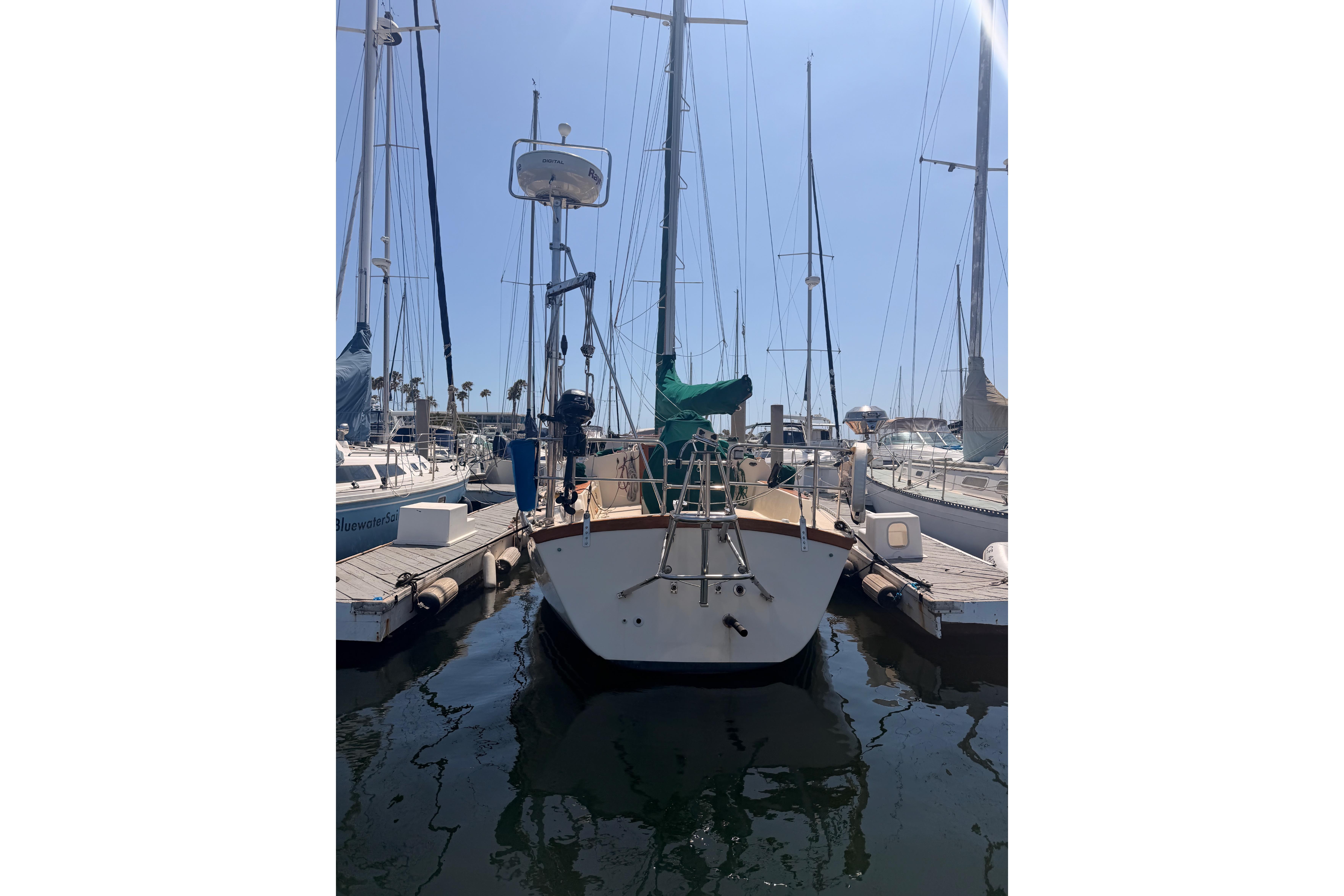Sailboat docked at marina, 1991 Caliber 33 model, sunny day.