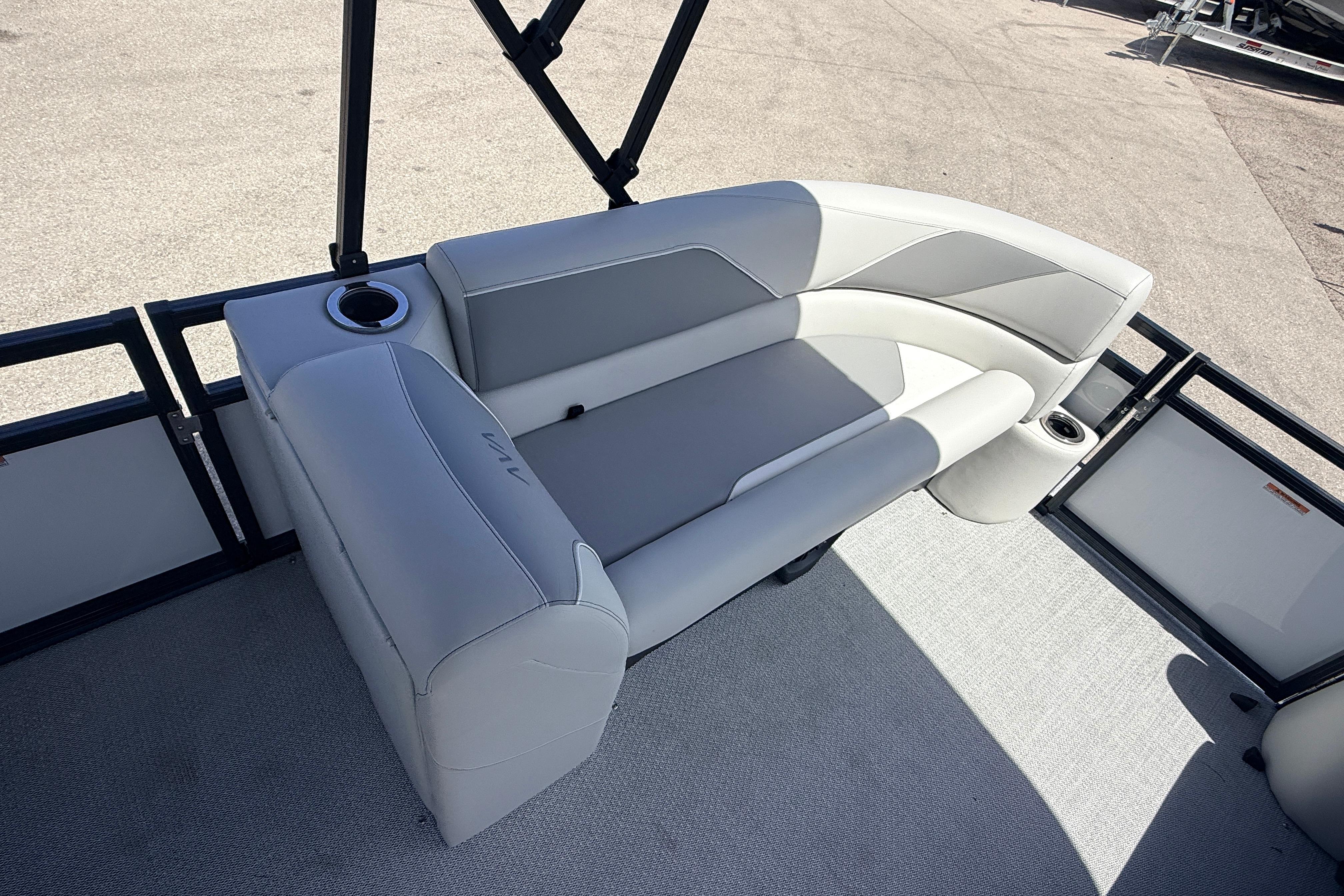 2026 Avalon 2385 Venture 85 Tri Toon boat with sleek seating and cup holders.