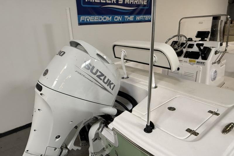 2026 Sea Pro 172 Bay boat with Suzuki outboard motor in showroom.