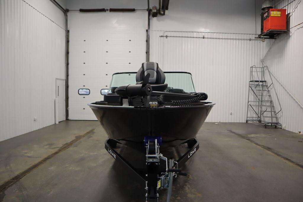 2026 Lowe Fishing Machine 175 boat in a spacious indoor garage.