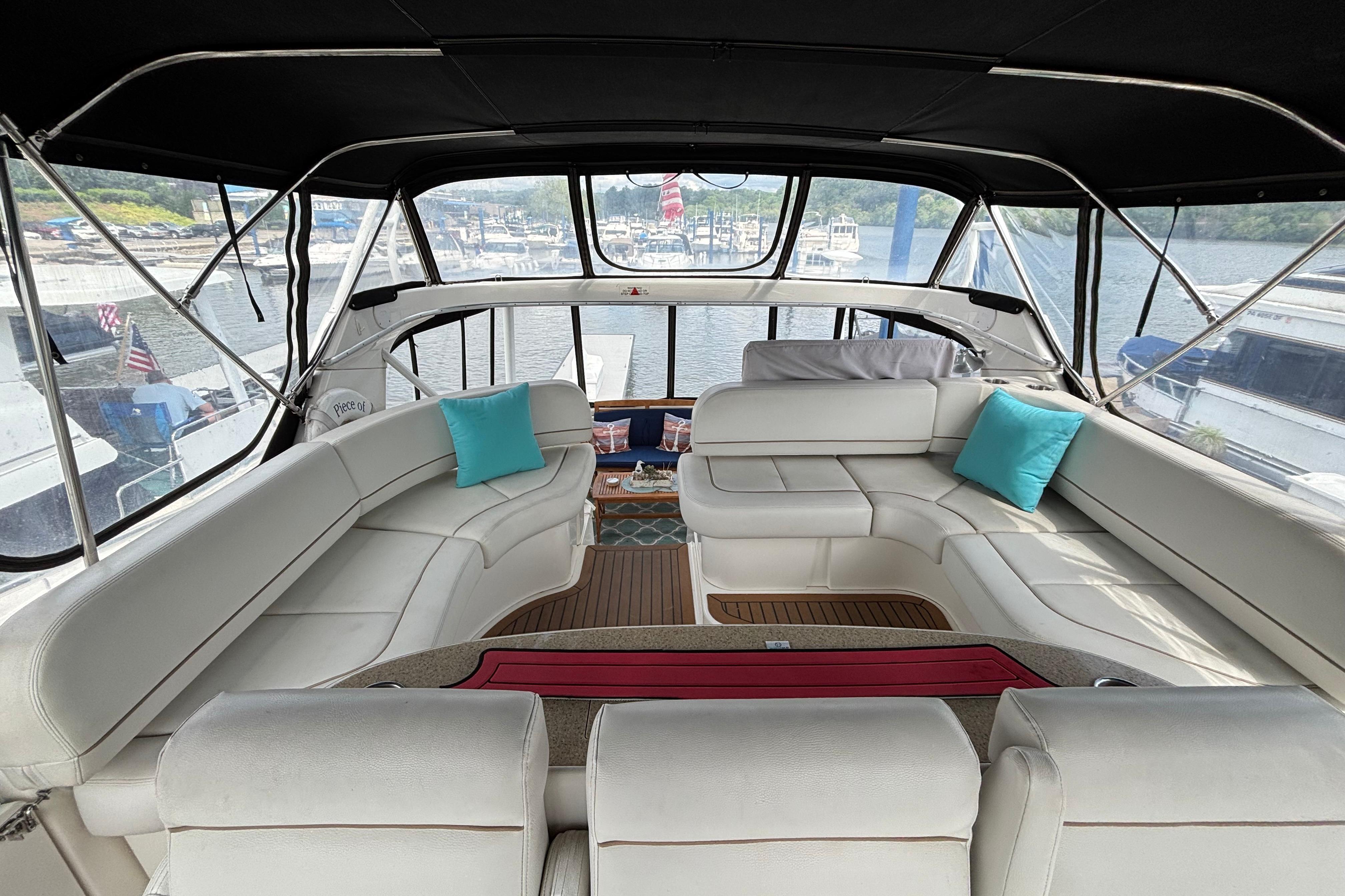 Luxurious interior of a 2007 Silverton 43 Motor Yacht with white seating and blue cushions.