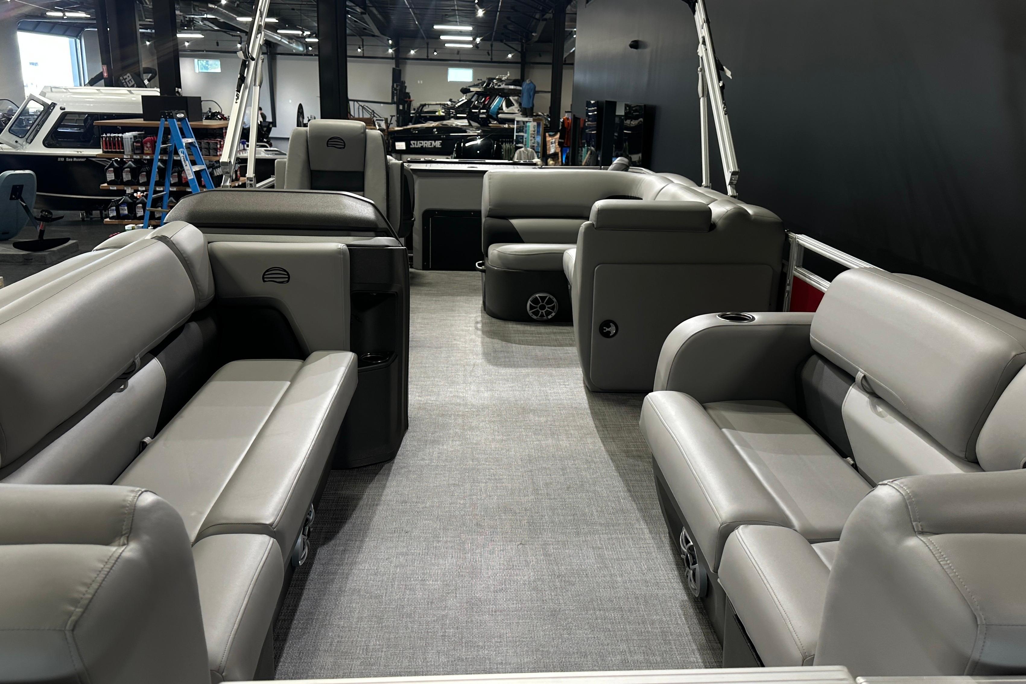 2026 Sun Tracker SportFish 22 DLX pontoon boat interior with gray seating and spacious layout.
