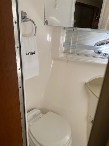 2004 Chaparral Signature 350 bathroom with toilet, towel, and mirror.