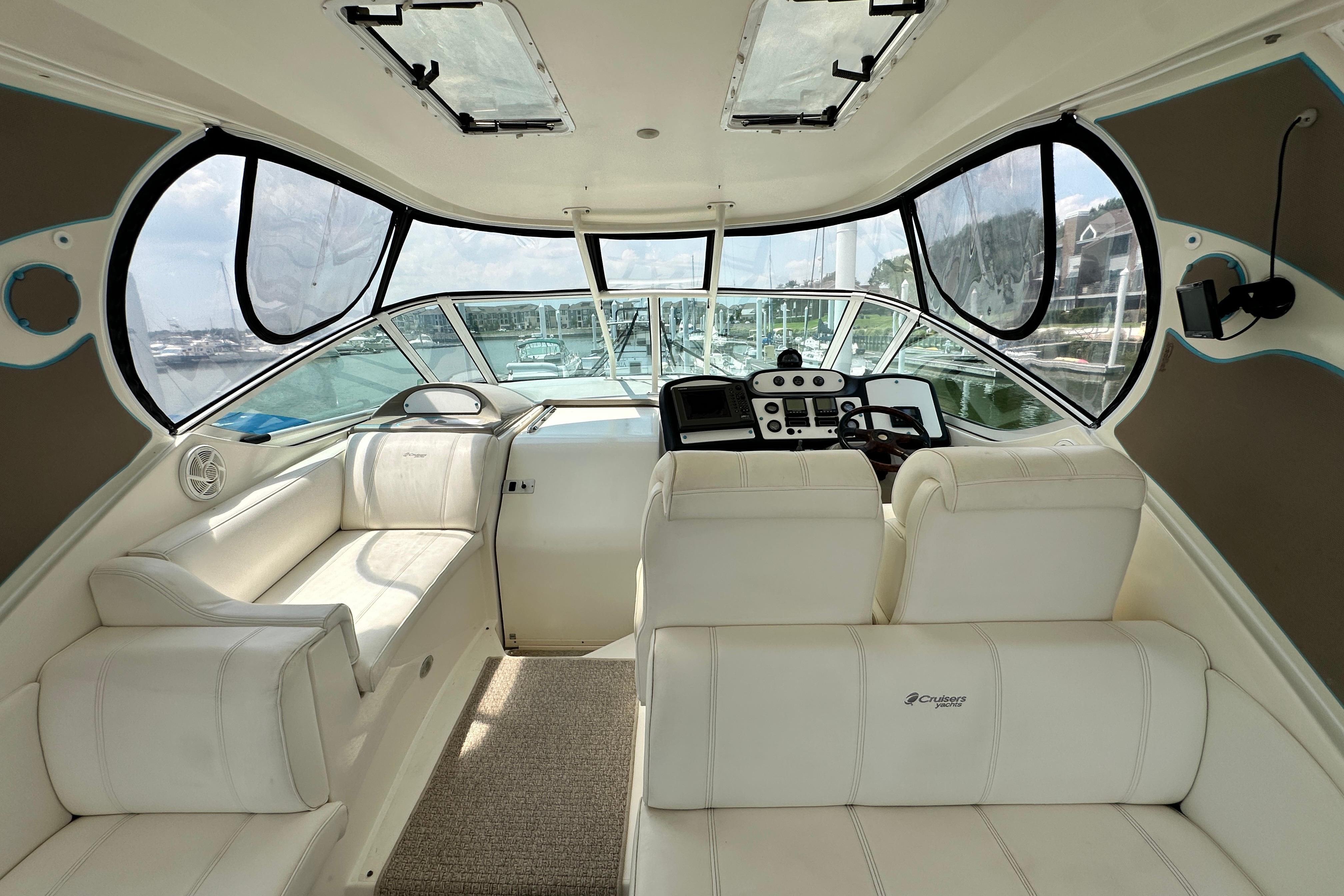 2004 Cruisers Yachts 405 Express Motoryacht interior with white seating and control panel.