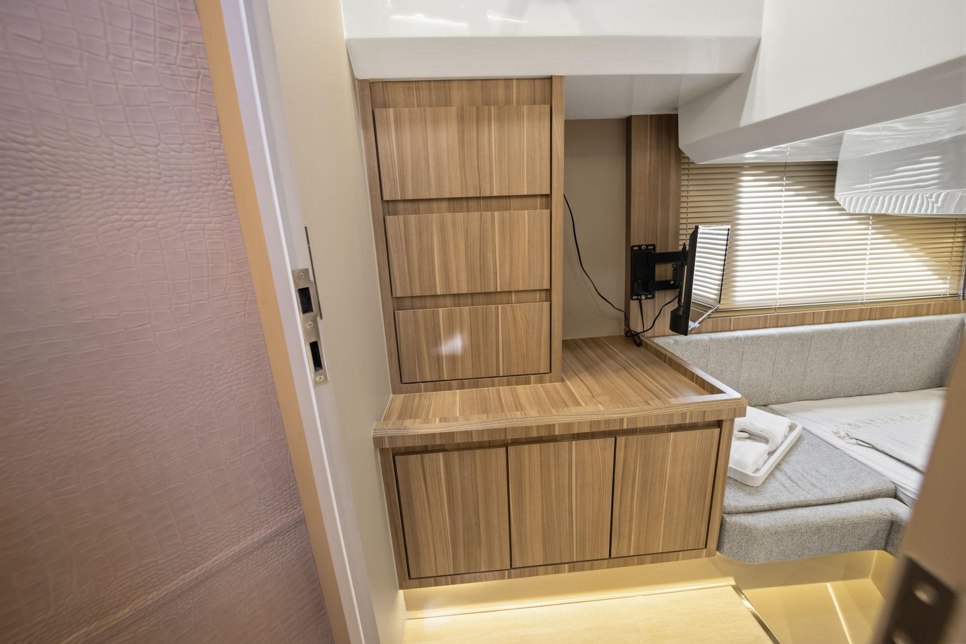 Modern interior of Hanover 447, 2026 model, featuring wood cabinetry and cozy seating area.
