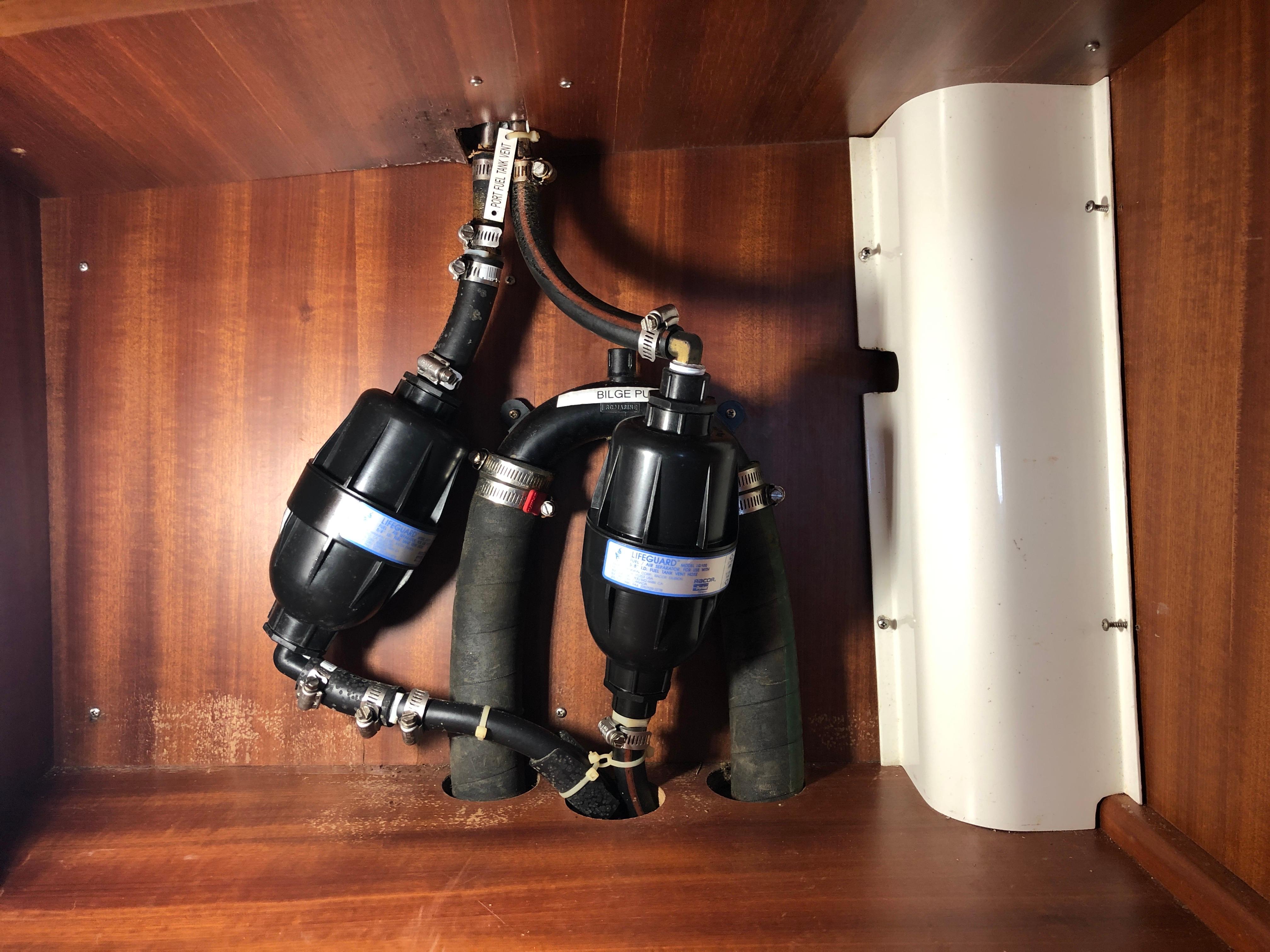 Boat engine compartment with hoses and filters, Outbound 46, 2008 model.
