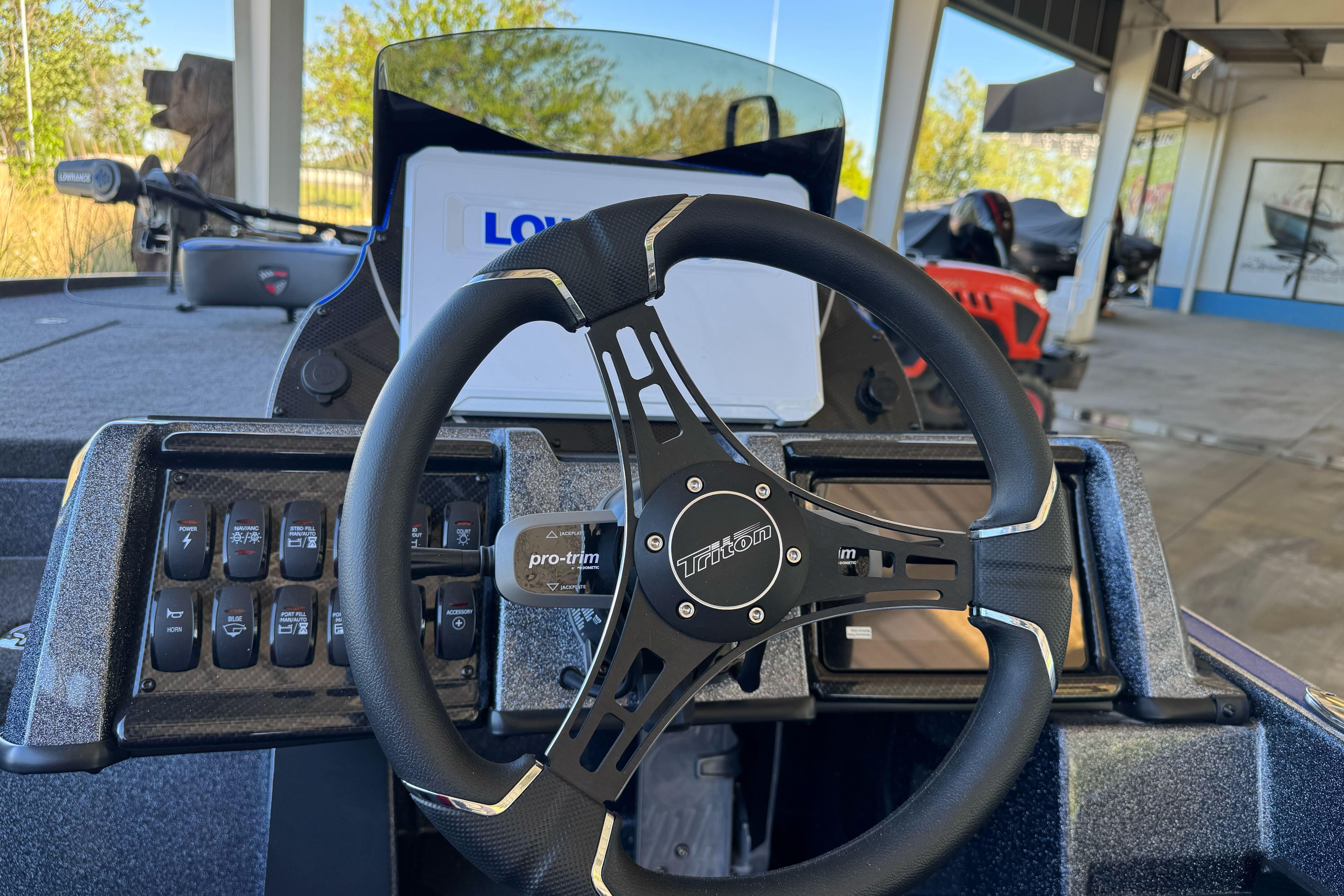 2026 Triton 21XP Patriot boat dashboard with steering wheel and control panel.