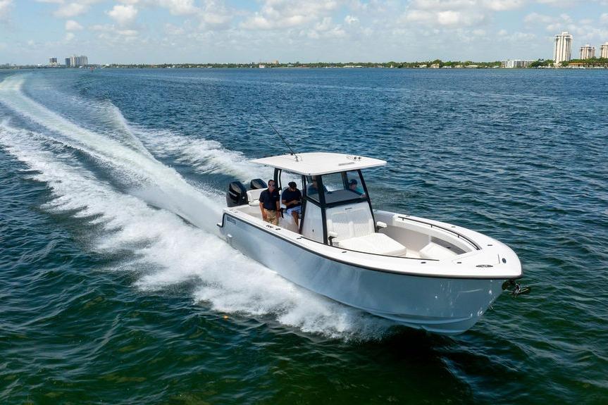 2027 Reef Runner 340 boat cruising on open water under a clear sky.