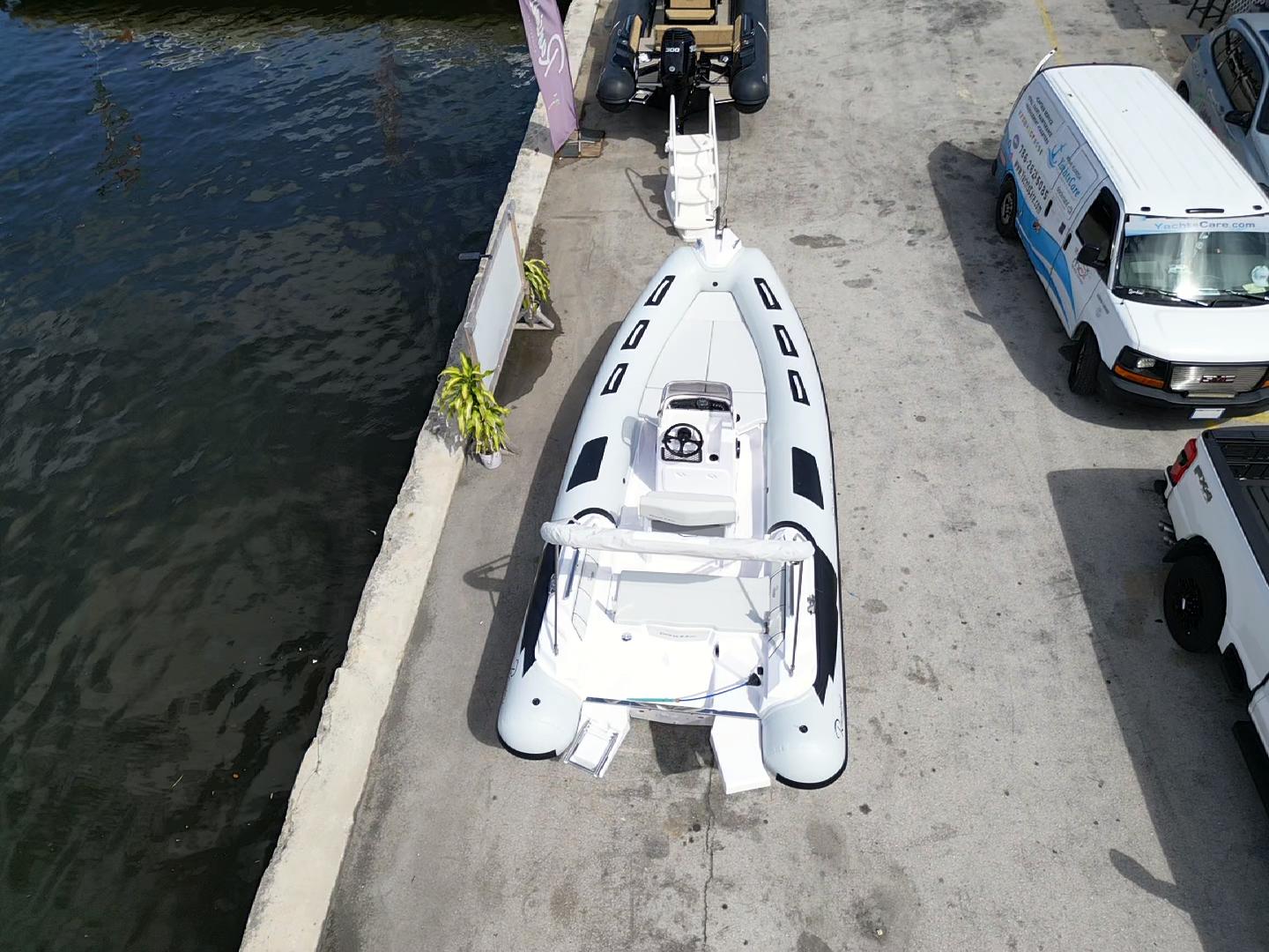 2025 Ranieri CAYMAN 19 Sport boat docked at marina, aerial view.