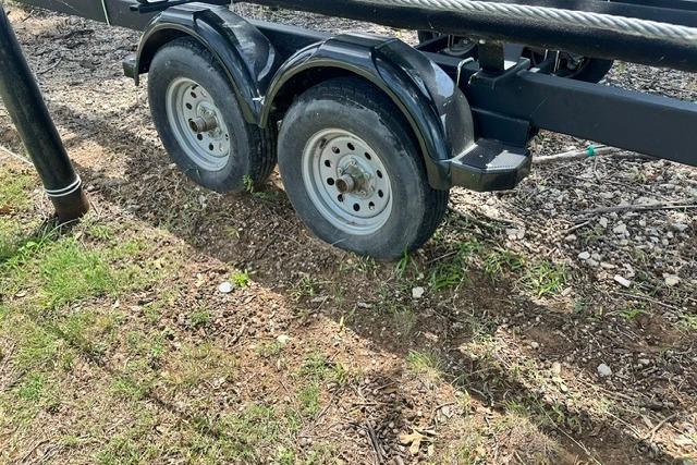 Trailer with flat tire for 2021 Bennington L Bowrider 25 Quad Bench boat.
