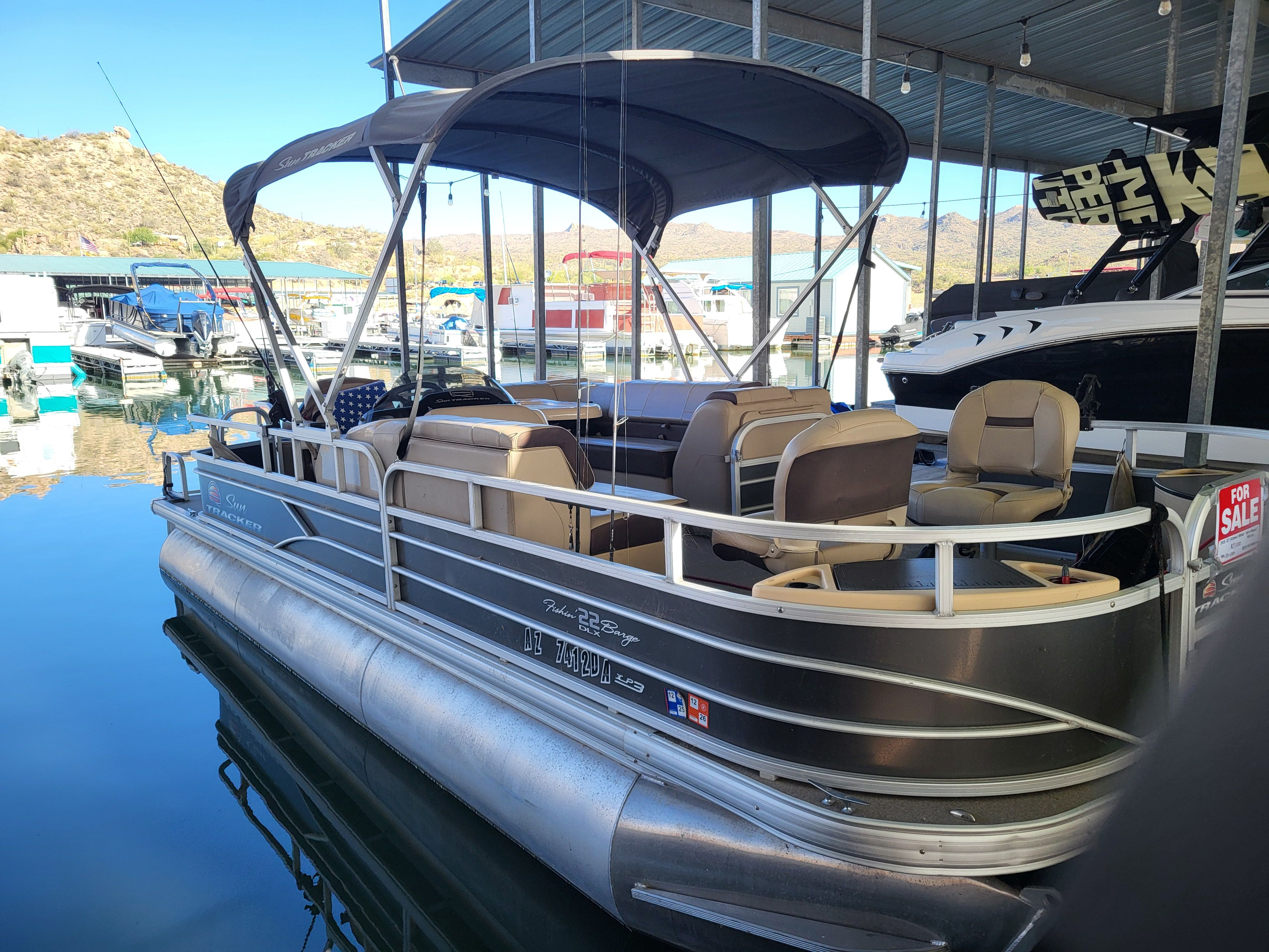 2018 Sun Tracker SFB22XP3 pontoon boat docked, available for sale.