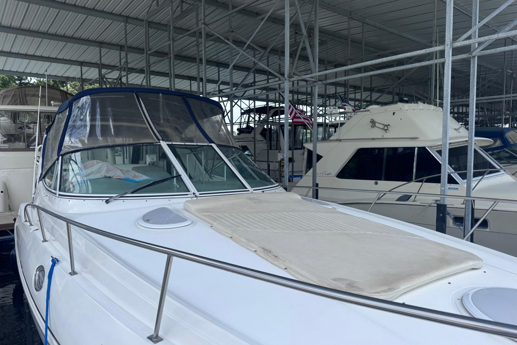 2002 Cruisers Yachts 3275 Express docked in a covered marina.