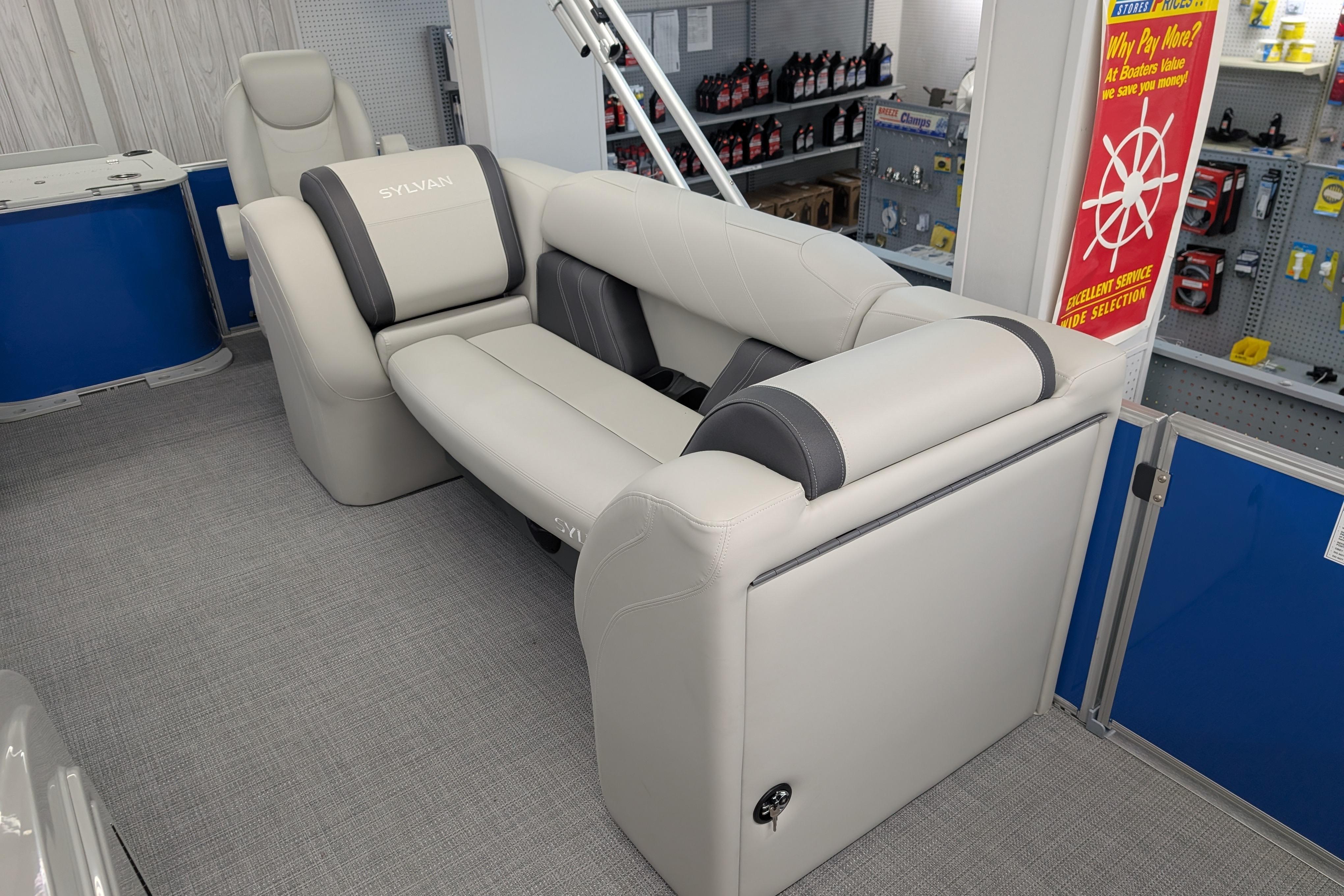 Luxurious seating on 2026 Sylvan Mirage Fish 8522 Party Fish boat in showroom.