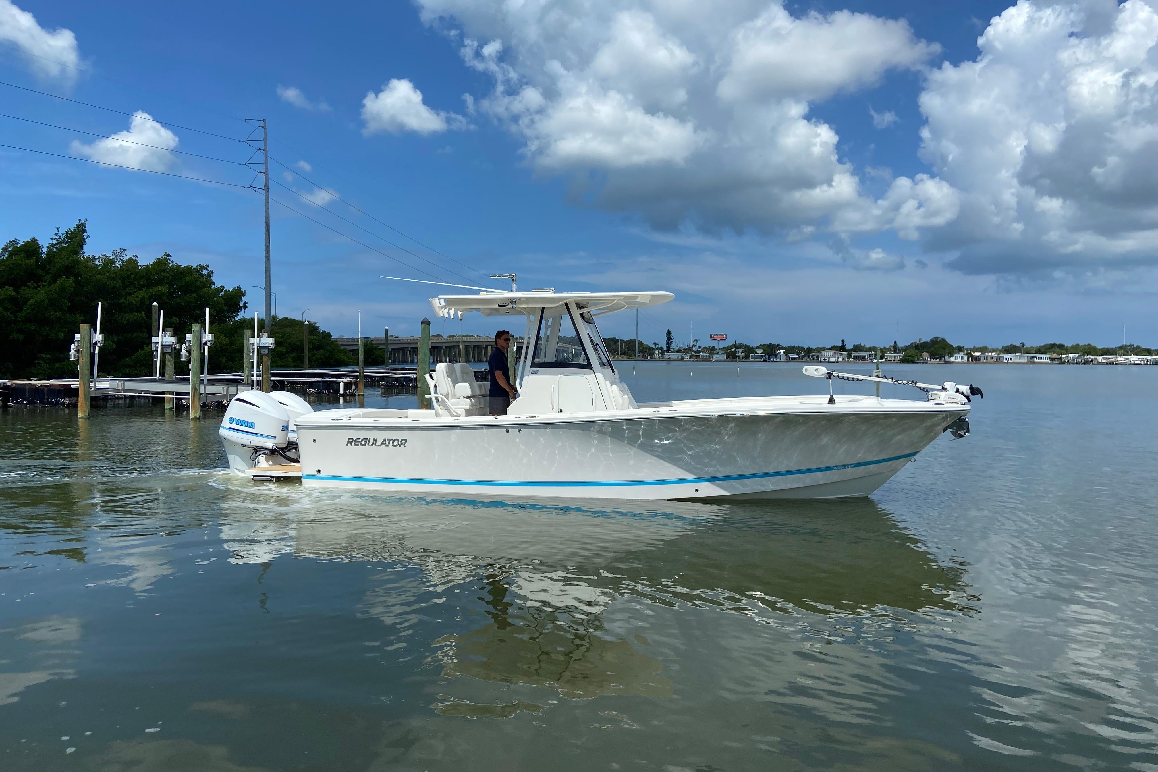 2021 Regulator 28 boat cruising on calm waters under a partly cloudy sky.