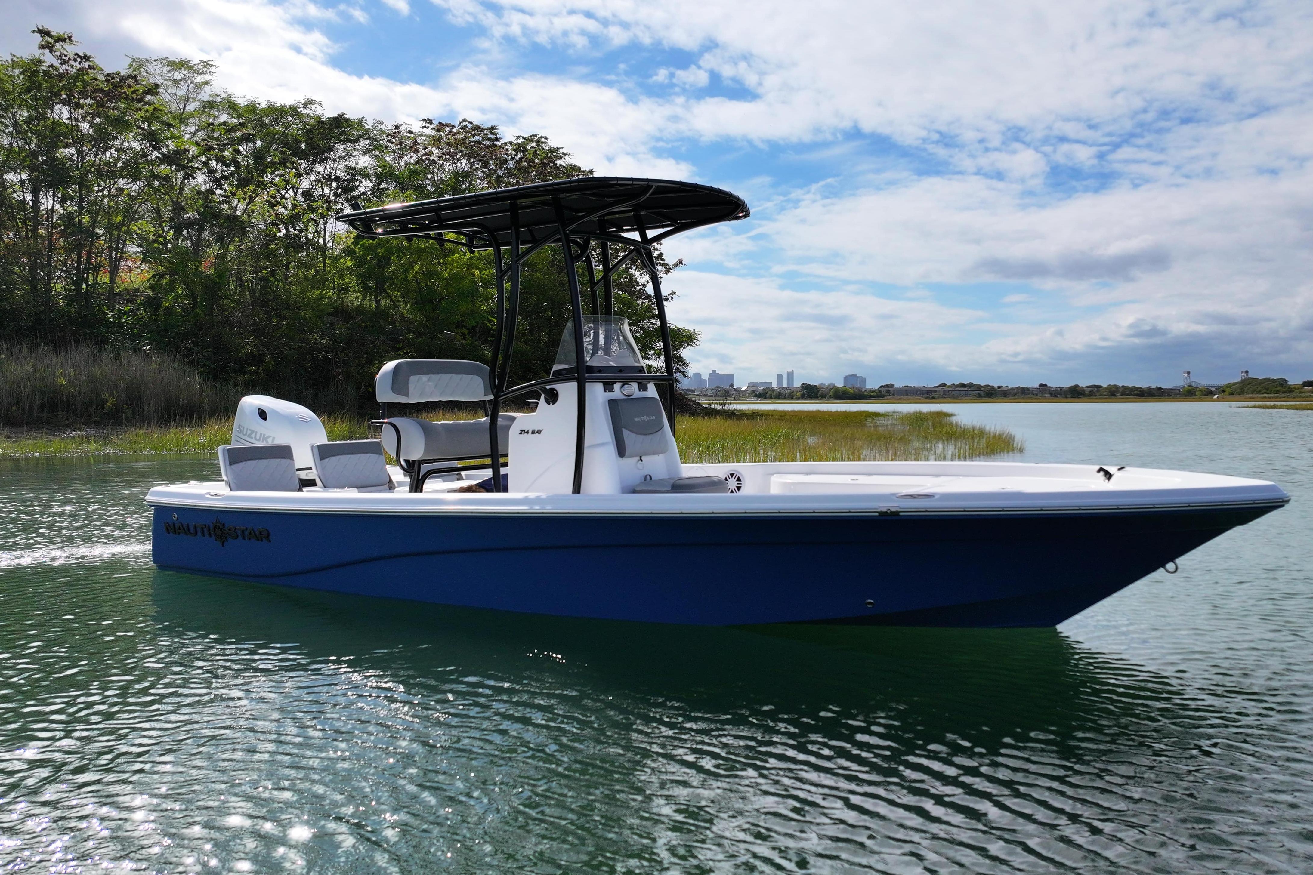 2026 NauticStar 214 Bay boat on calm water, featuring sleek design and modern amenities.