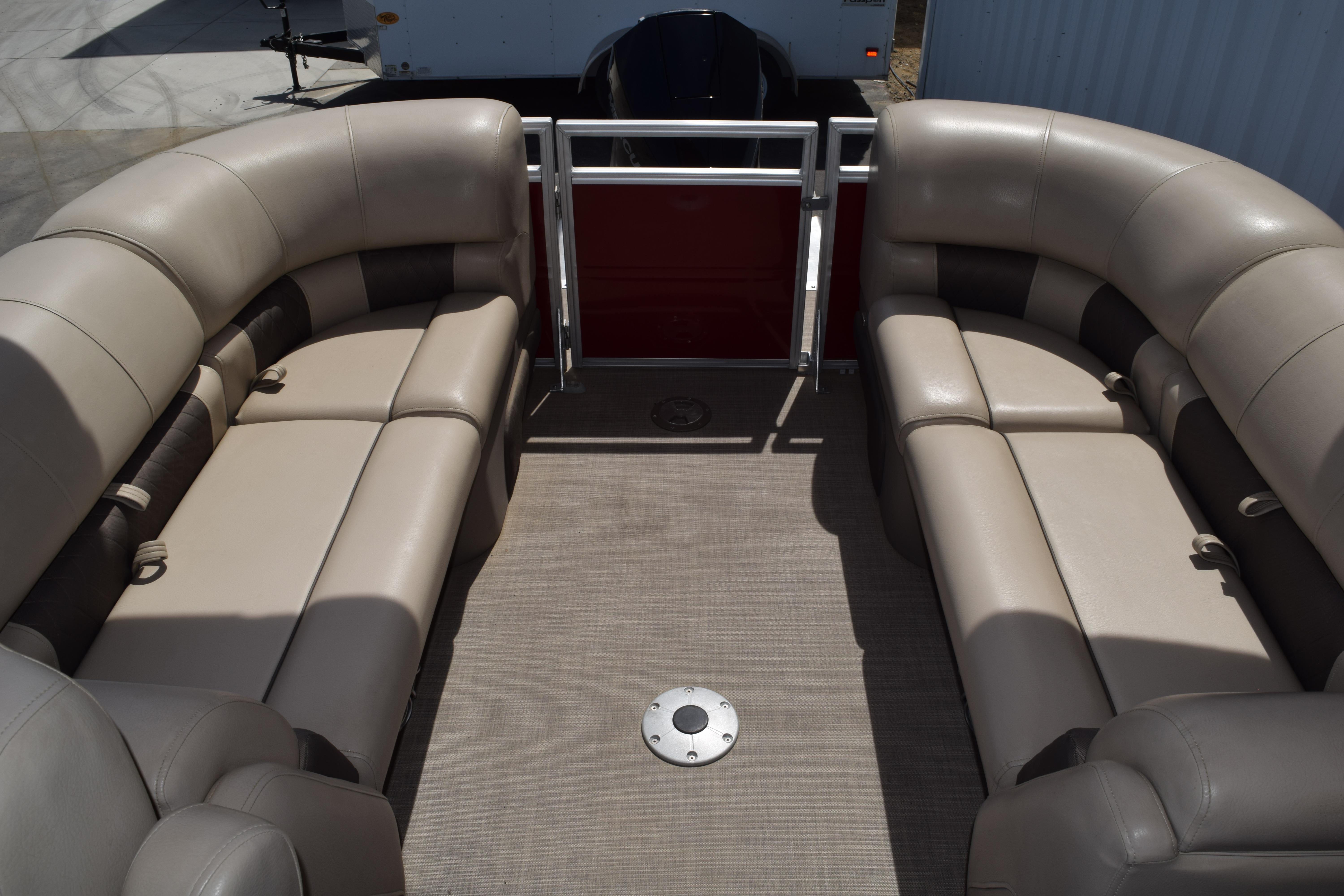 2025 Sun Tracker Party Barge 22 XP3 interior with beige seating and spacious layout.