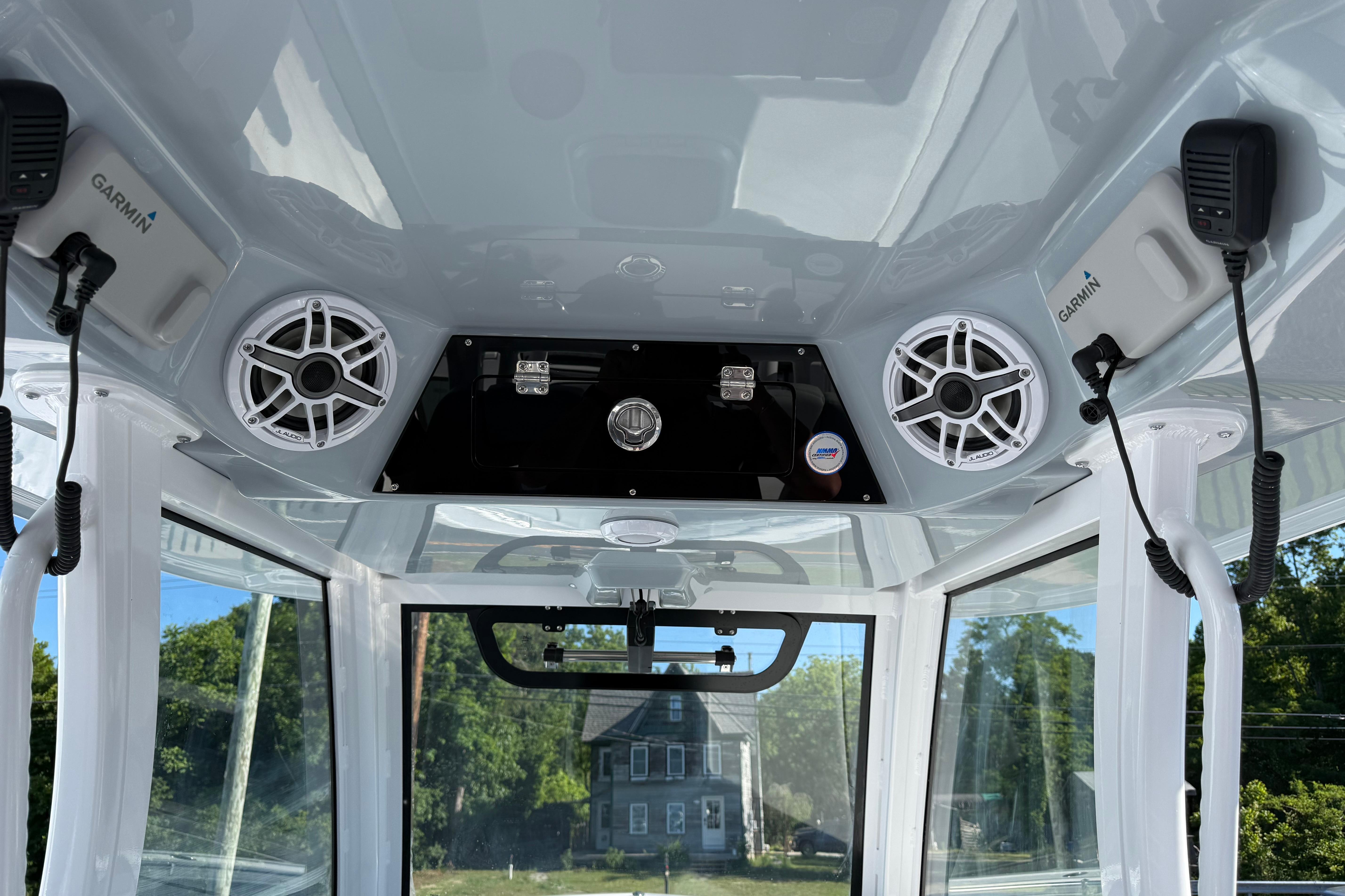 Interior view of 2026 Sportsman Open 322 Center Console with speakers and Garmin devices.