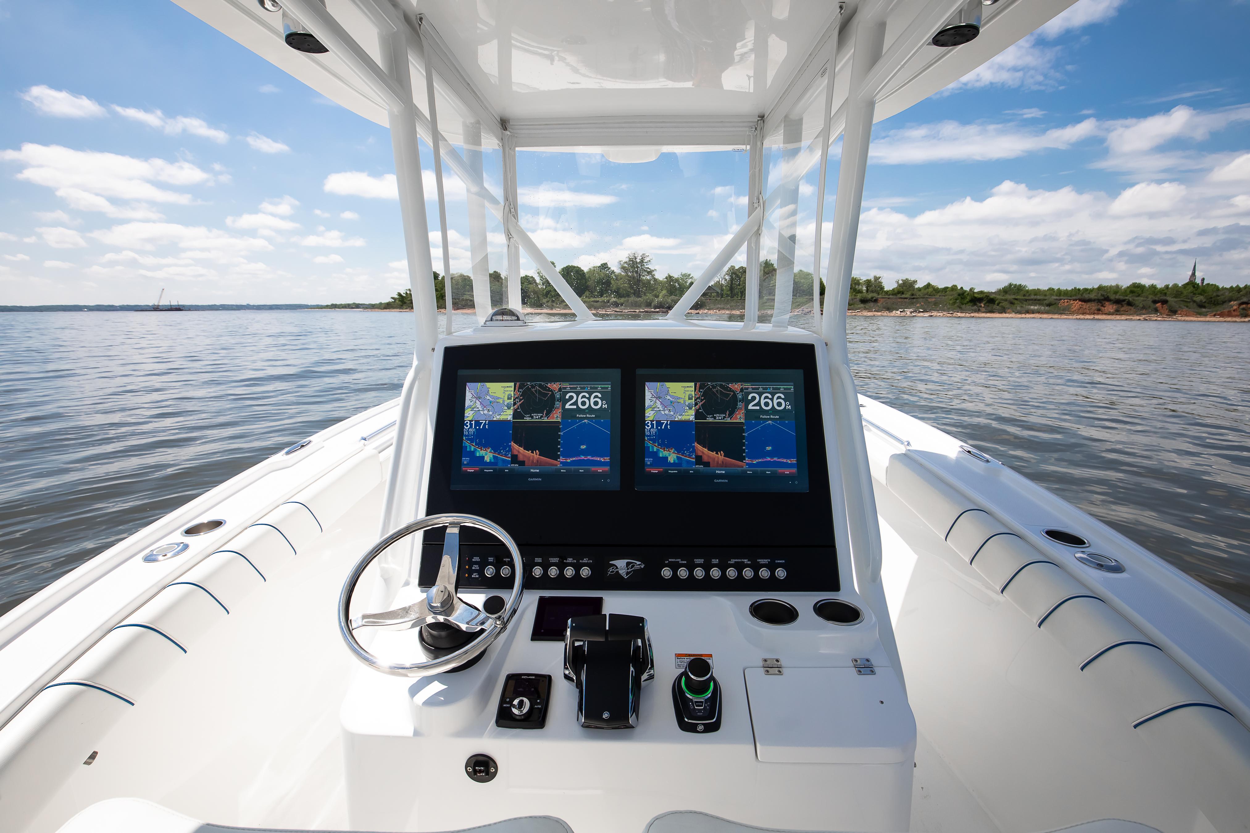 2025 Buddy Davis 28 Center Console boat dashboard with dual navigation screens on open water.
