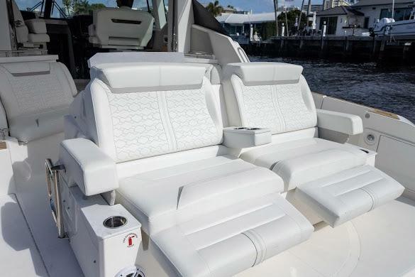 2022 Tiara Sport 43 LE luxury boat seating with white upholstery and armrests.