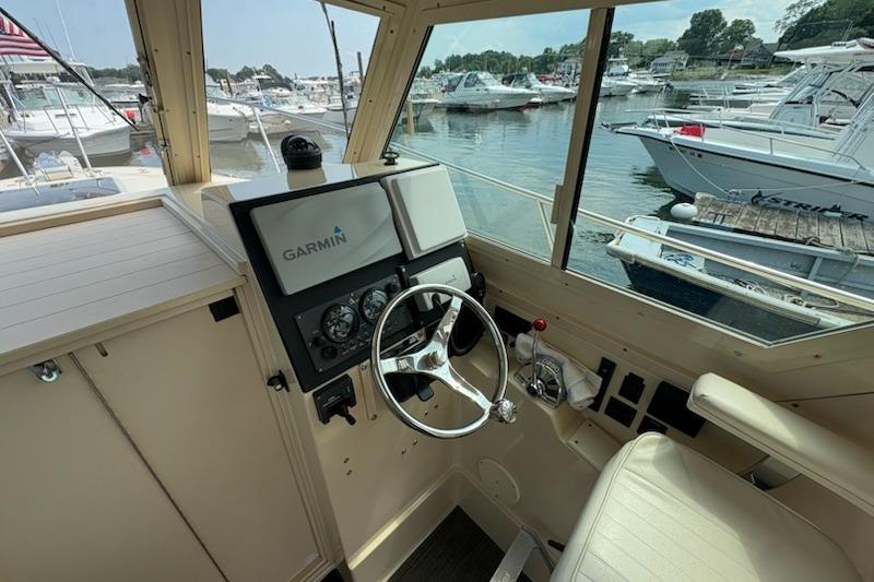 2003 Albin 28 Tournament Express helm with Garmin navigation, docked at a marina.
