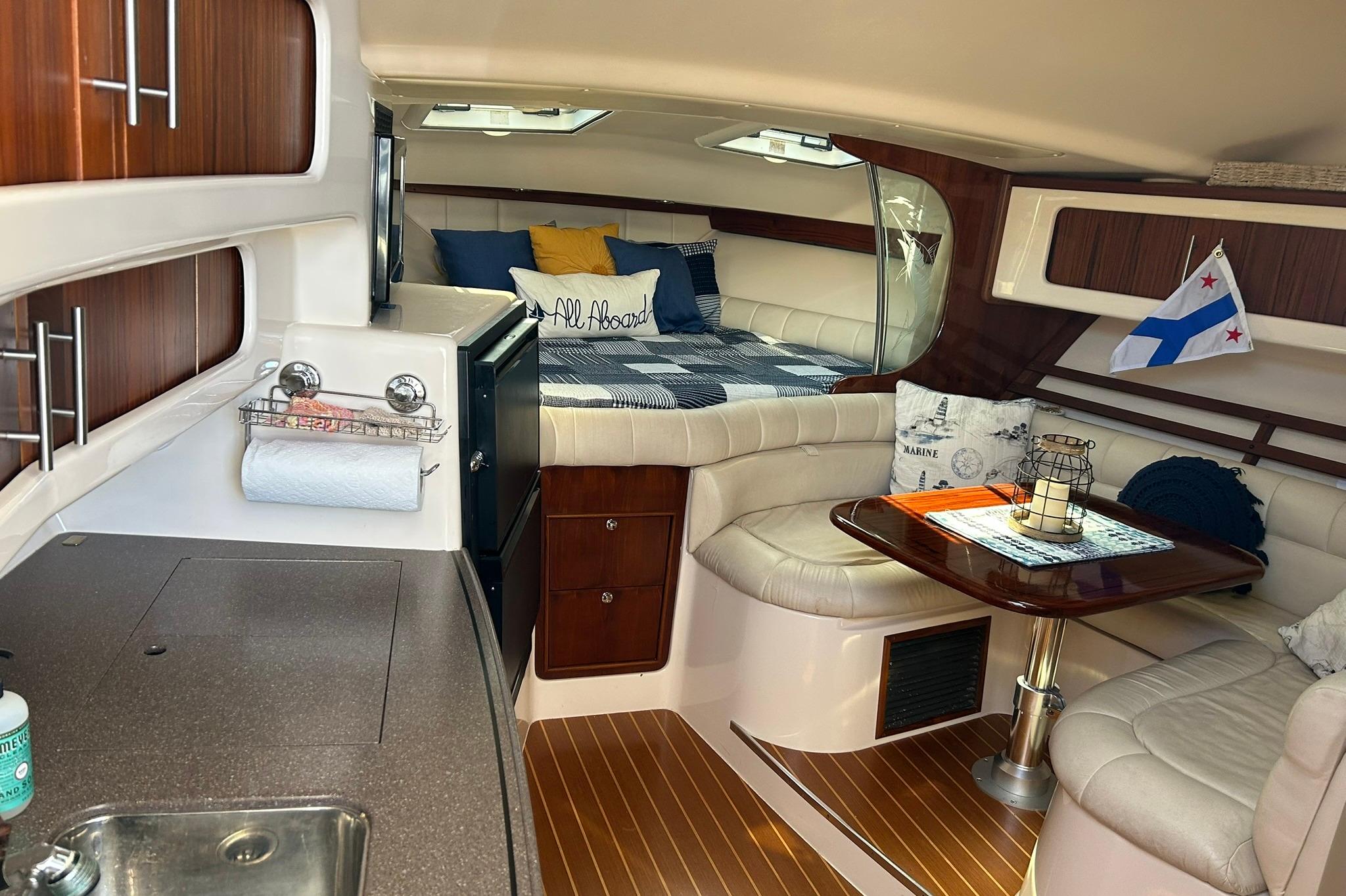 Interior of 2007 Grady-White Express 360 boat with cozy seating and kitchenette.