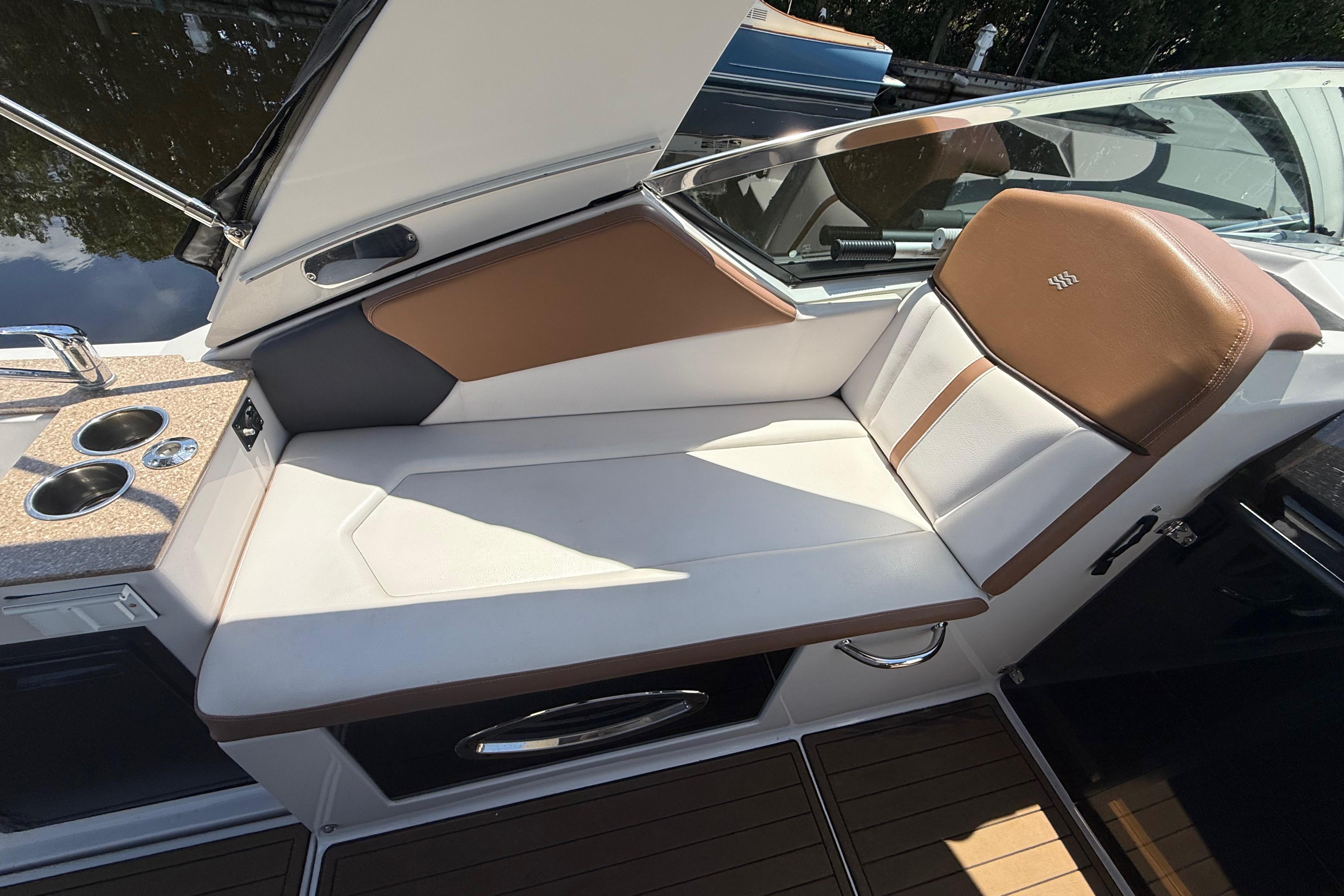 2017 Four Winns V275 boat interior with brown and white seating, cup holders, and sleek design.