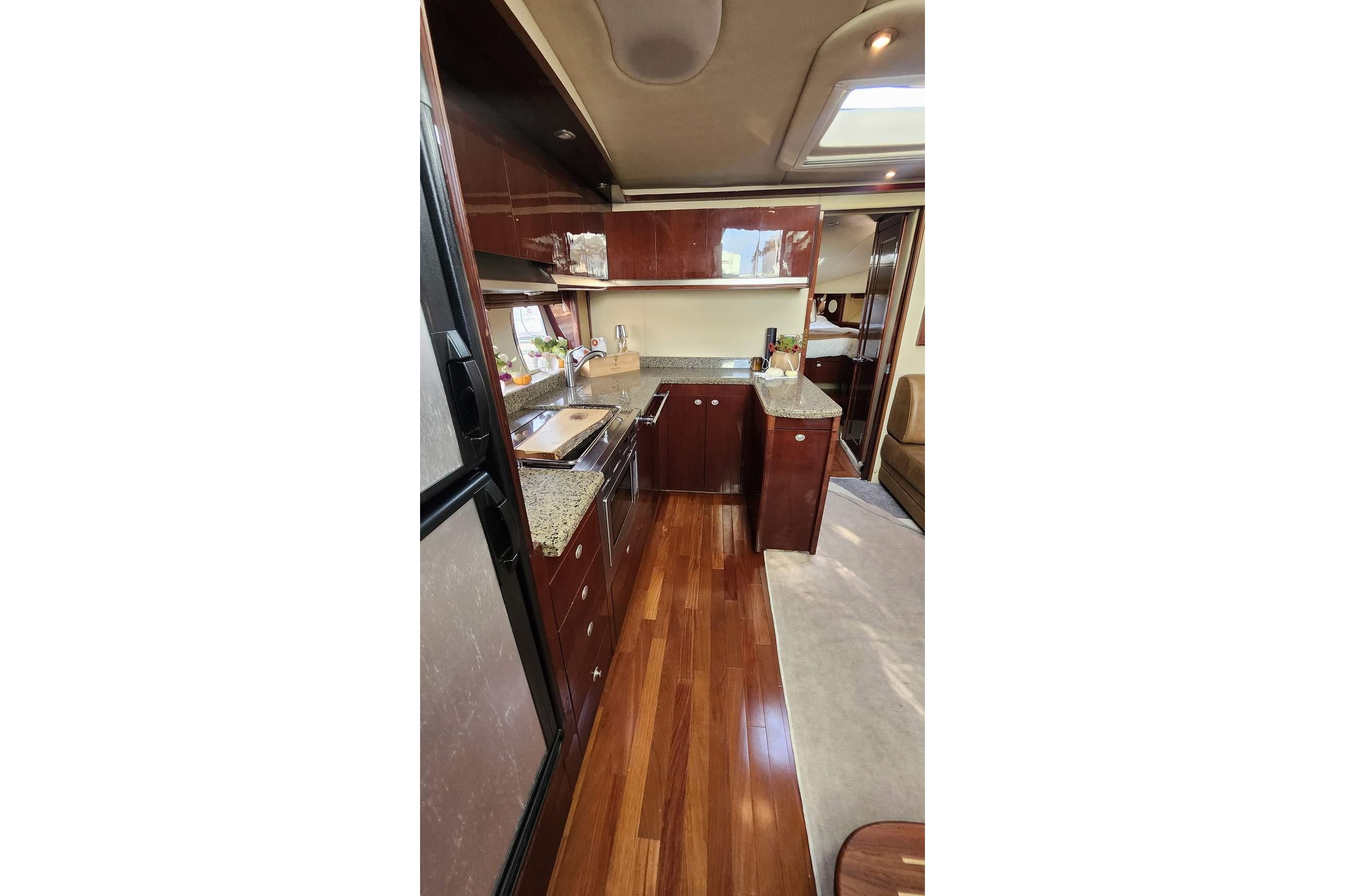 Luxurious 2007 Sea Ray 480 Sundancer yacht interior with elegant wood cabinetry and modern kitchen.