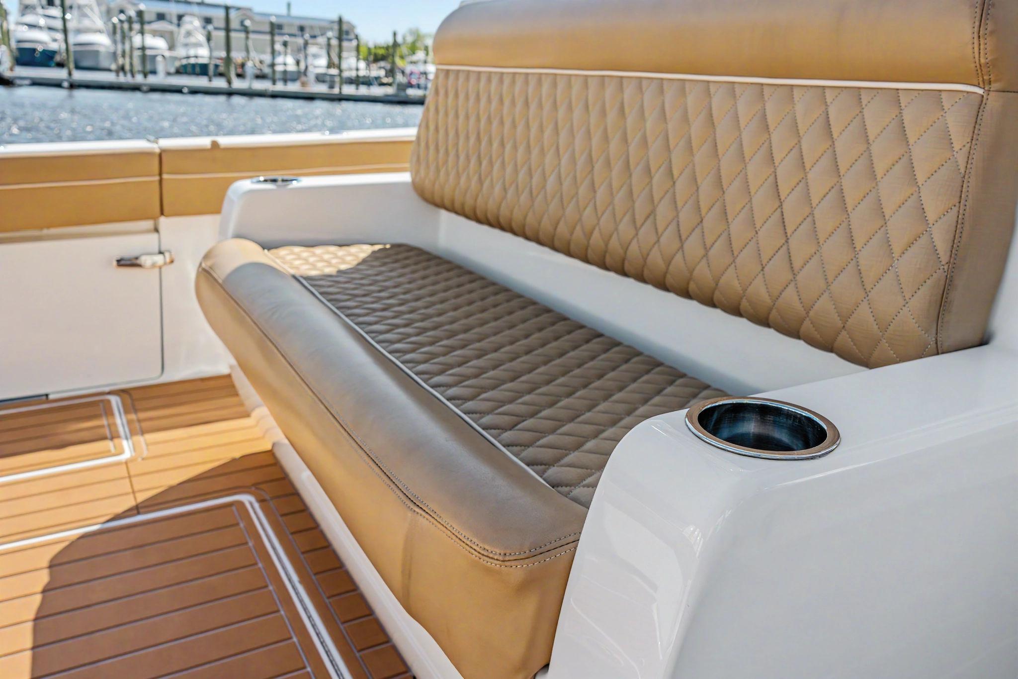 Luxurious seating on 2021 Valhalla Boatworks V-41 with diamond-stitched upholstery and cup holder.