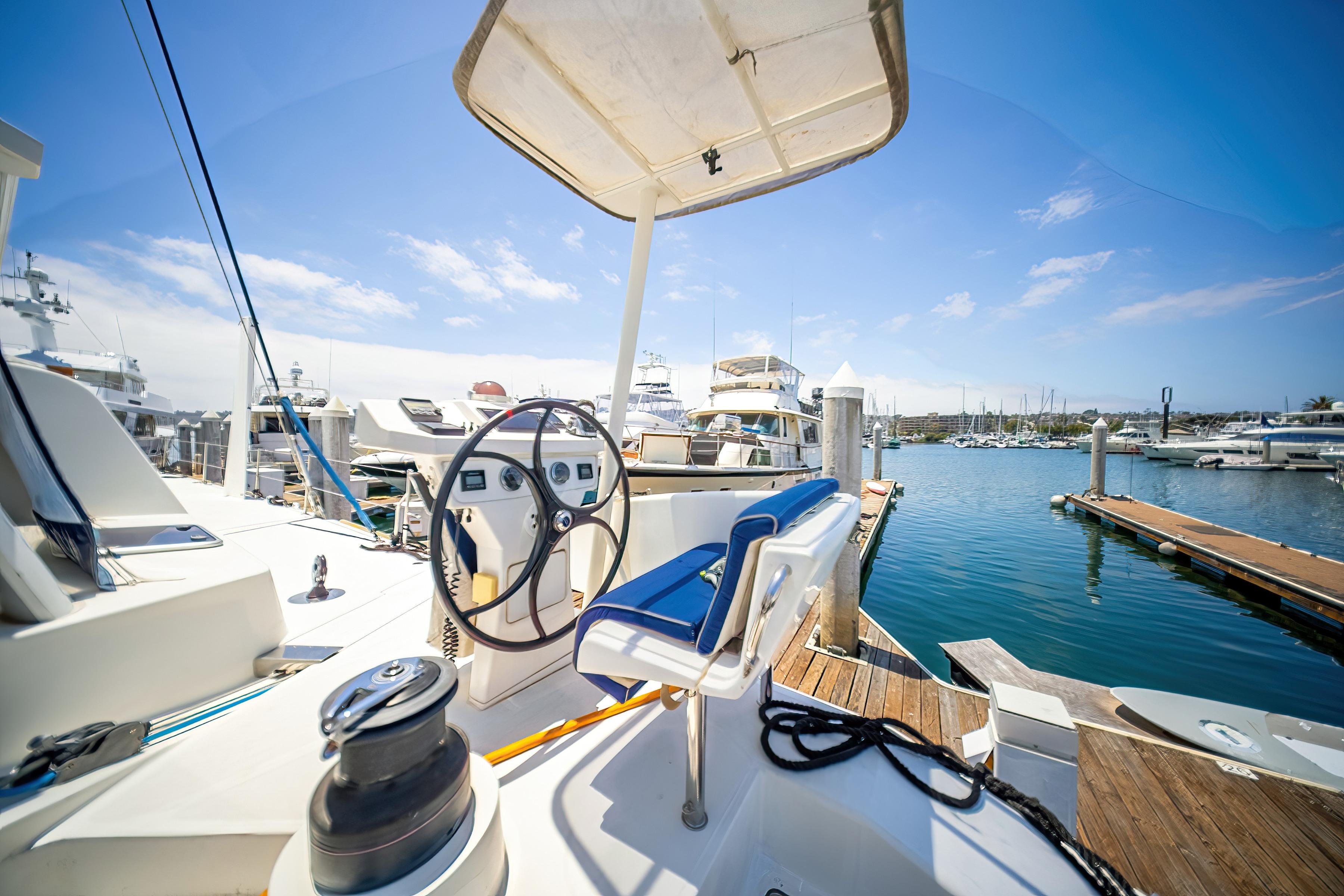 Cockpit view of 2009 Catana 65 yacht docked at marina under clear blue sky.
