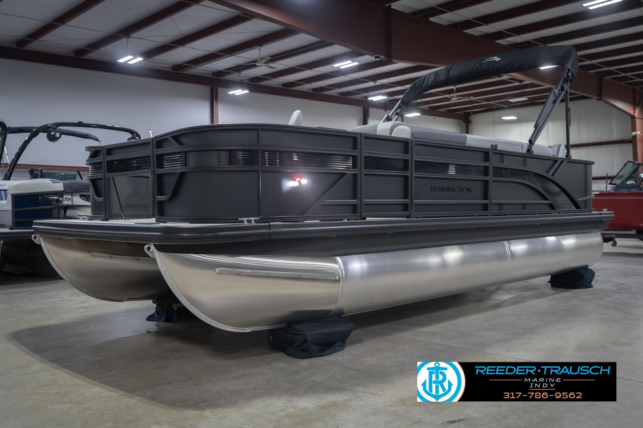 2026 Bennington 21 SF pontoon boat in showroom, featuring sleek design and modern amenities.
