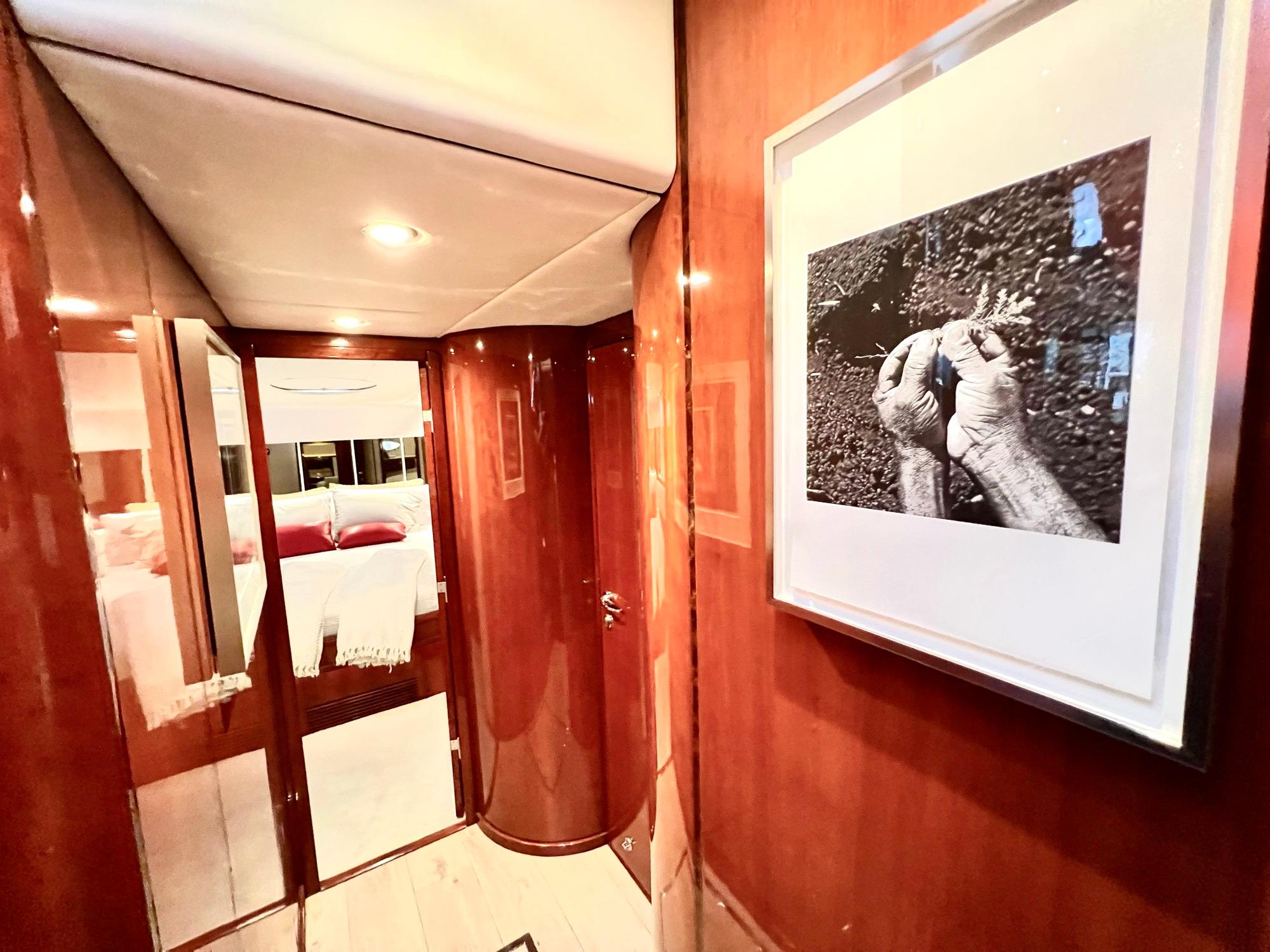 Interior hallway of 1999 Fairline Squadron 65 yacht with framed artwork.