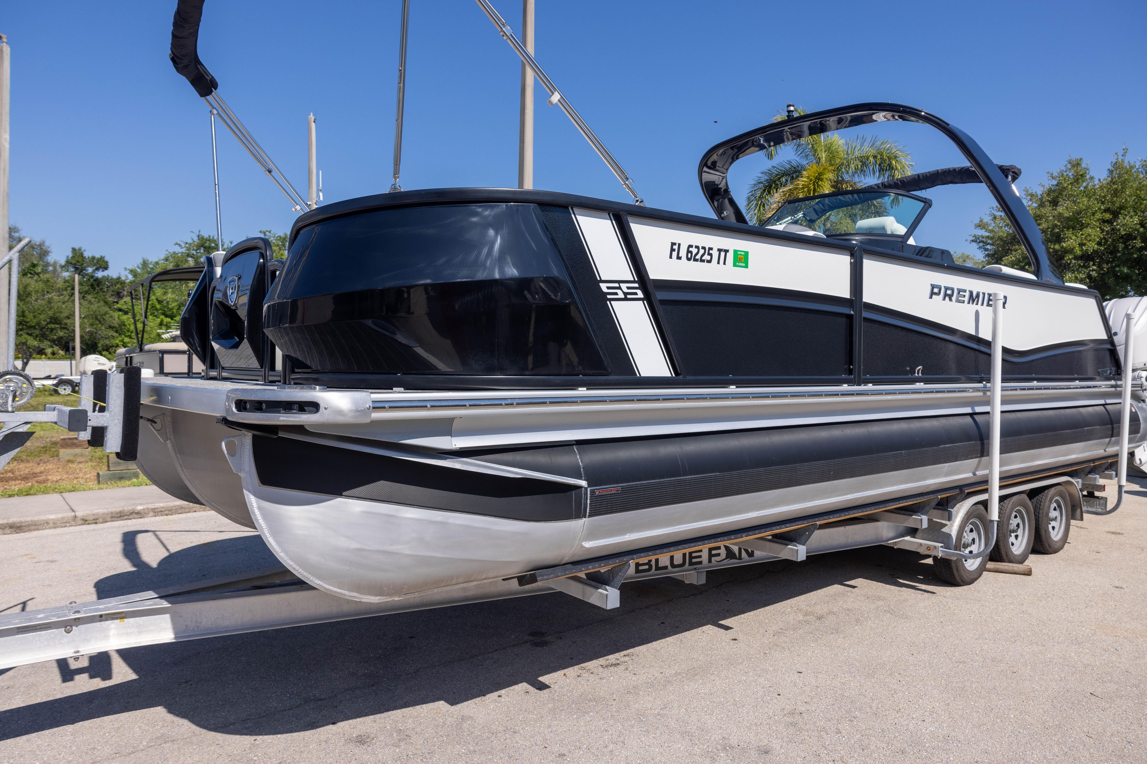 2024 Premier 270 Super Sport pontoon boat on trailer, sleek design, sunny day.