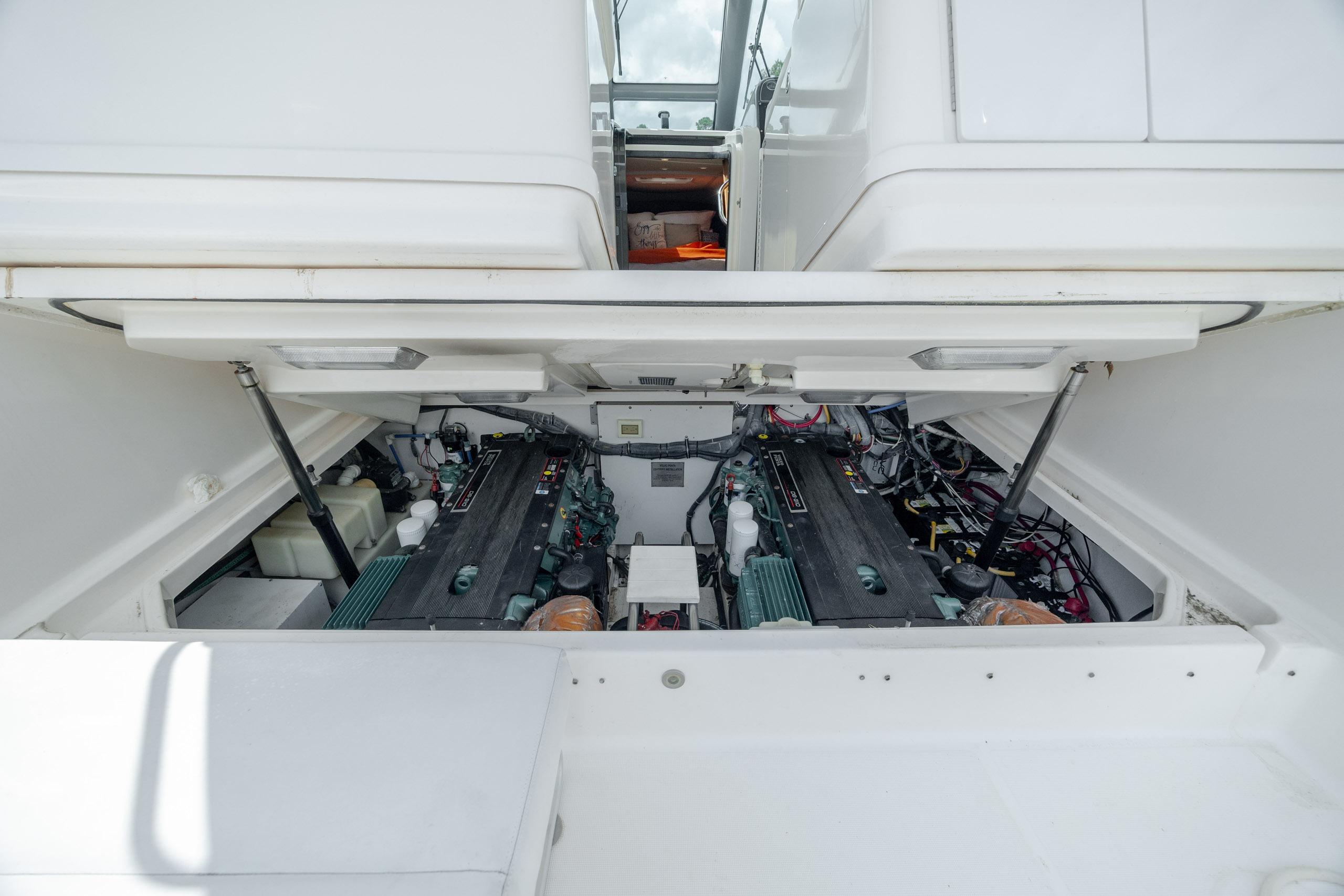 Engine compartment of a 2004 Tiara Yachts 3200 Open, showcasing dual engines and mechanical components.