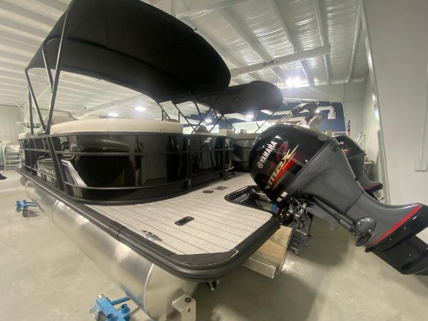 2024 Starcraft EXS 1 pontoon boat with Yamaha outboard motor in showroom.