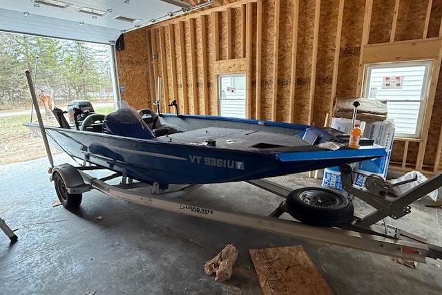 2018 Alumacraft Pro 185 boat in garage, blue exterior, on trailer.