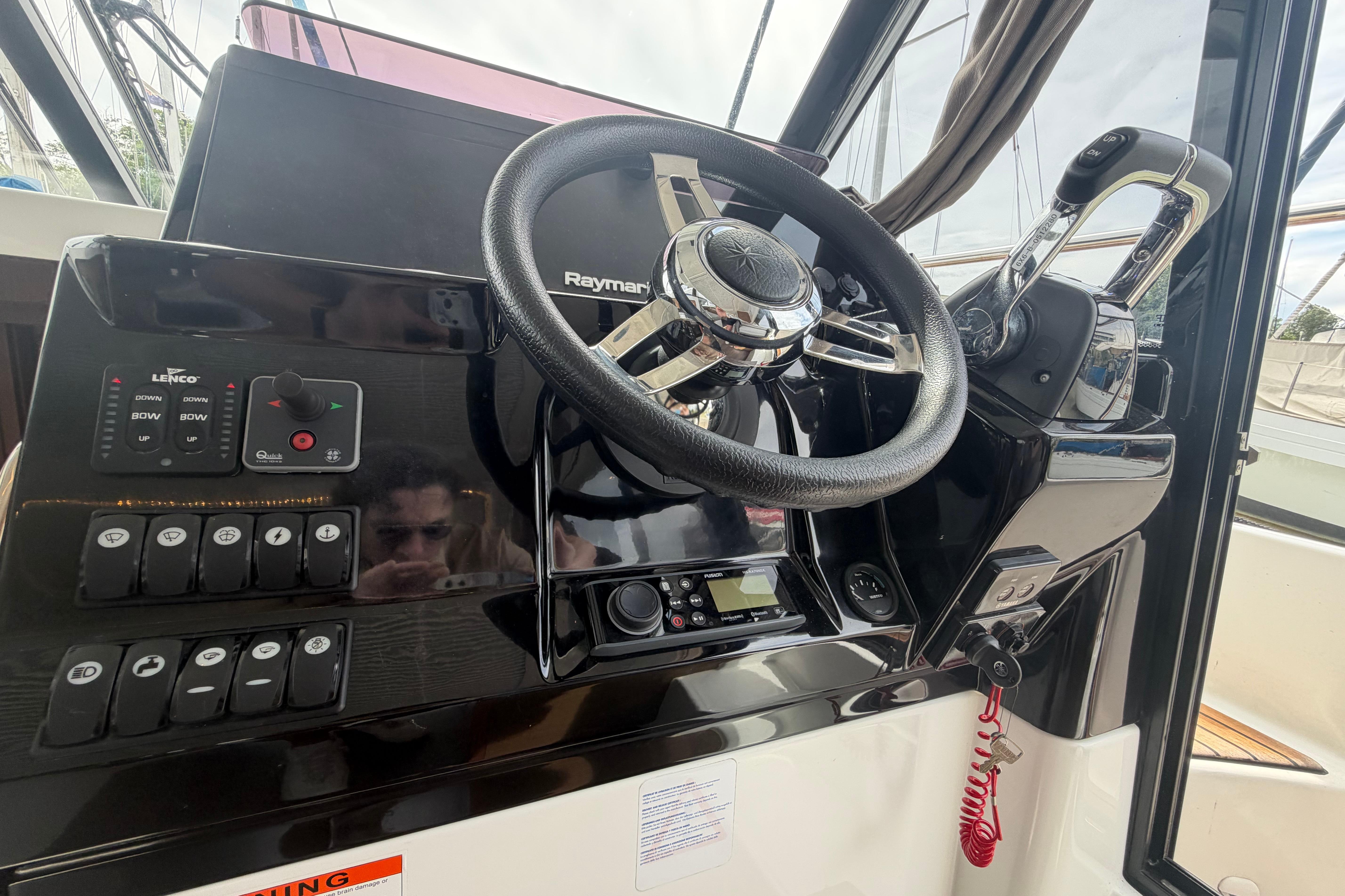 Control panel of 2020 Jeanneau NC 1095 Coupe boat with steering wheel and navigation controls.