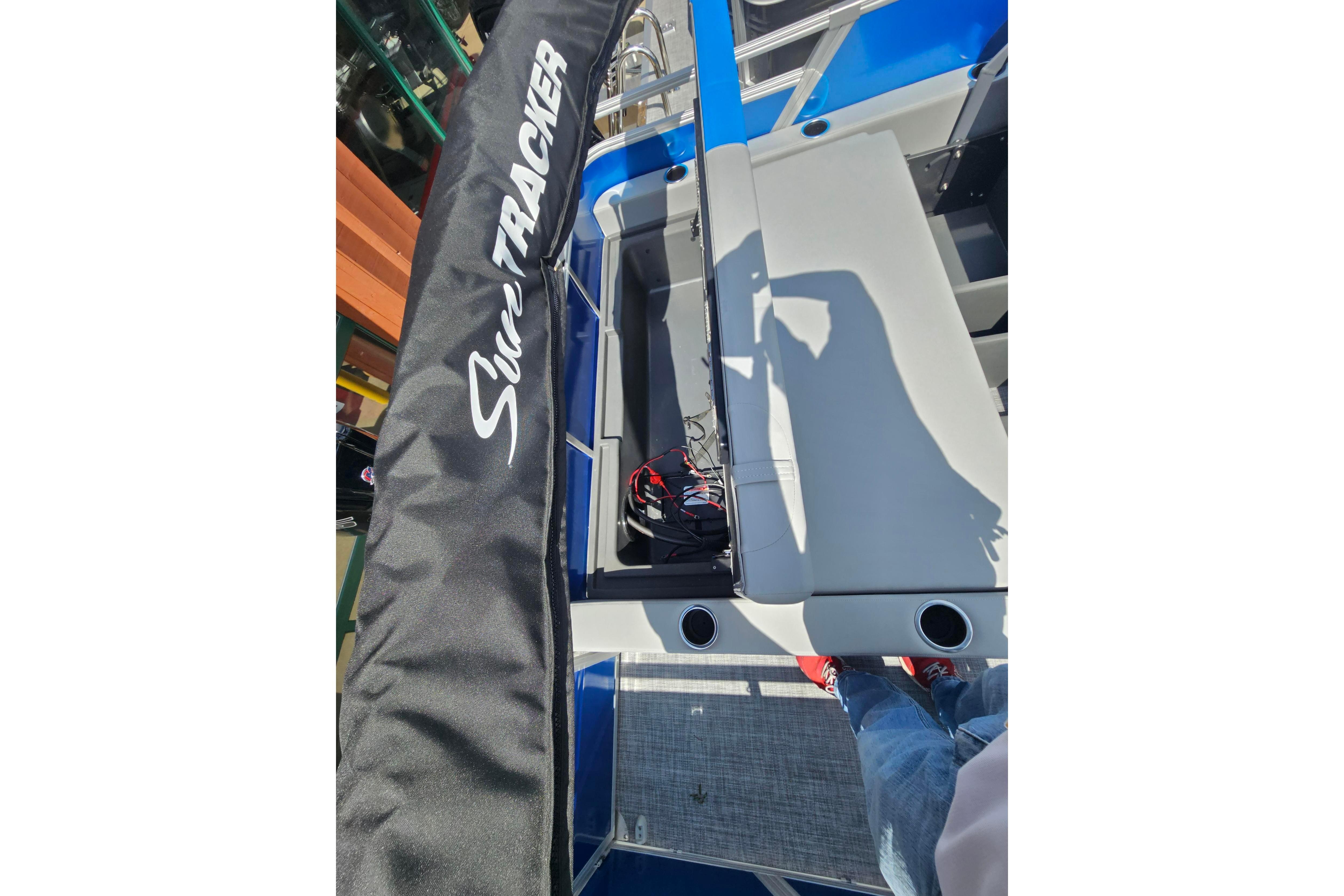 2026 Sun Tracker Party Barge 22 RF DLX interior with seating and cover.