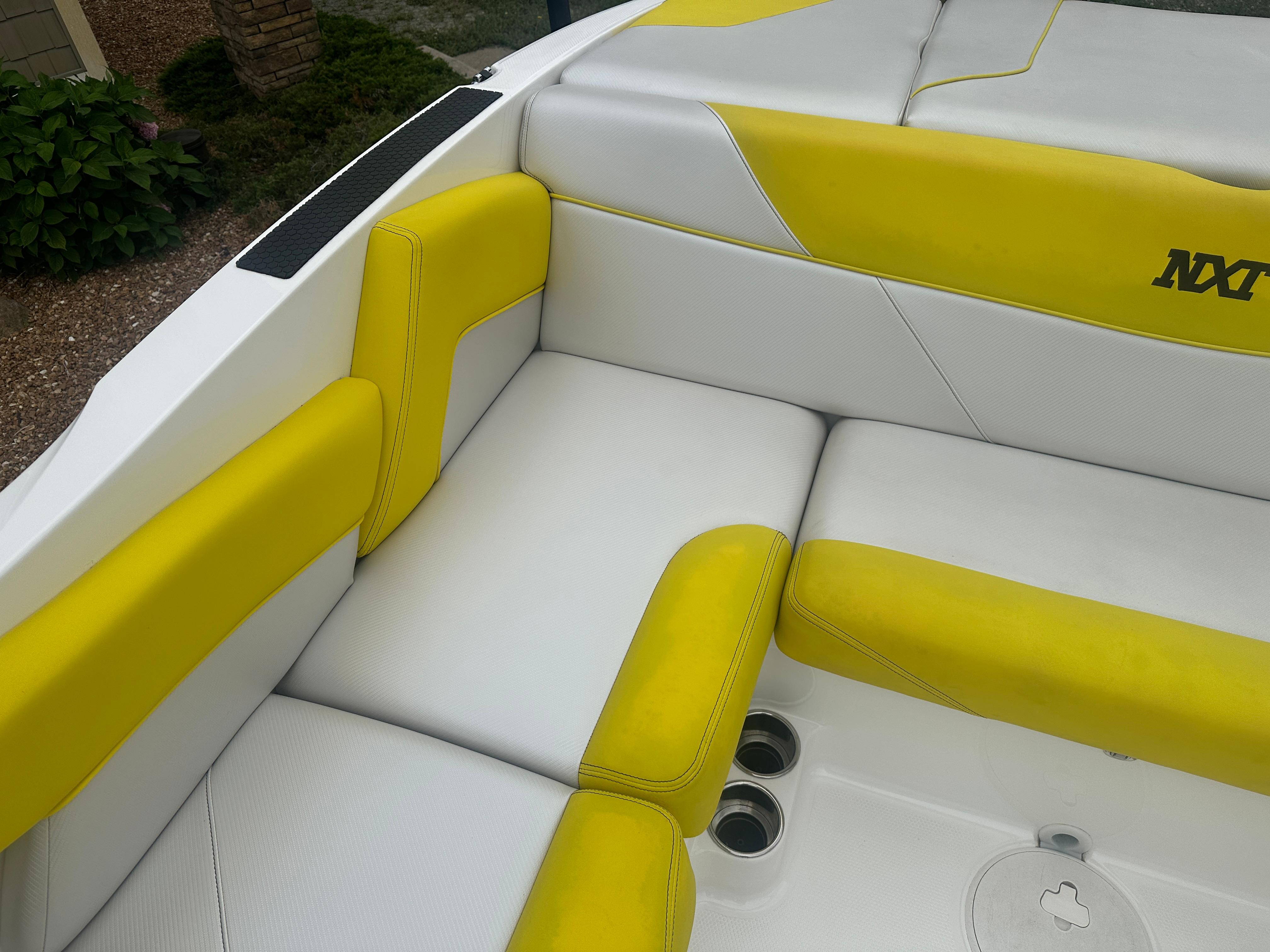 2018 MasterCraft NXT22 boat interior with yellow and white seating.